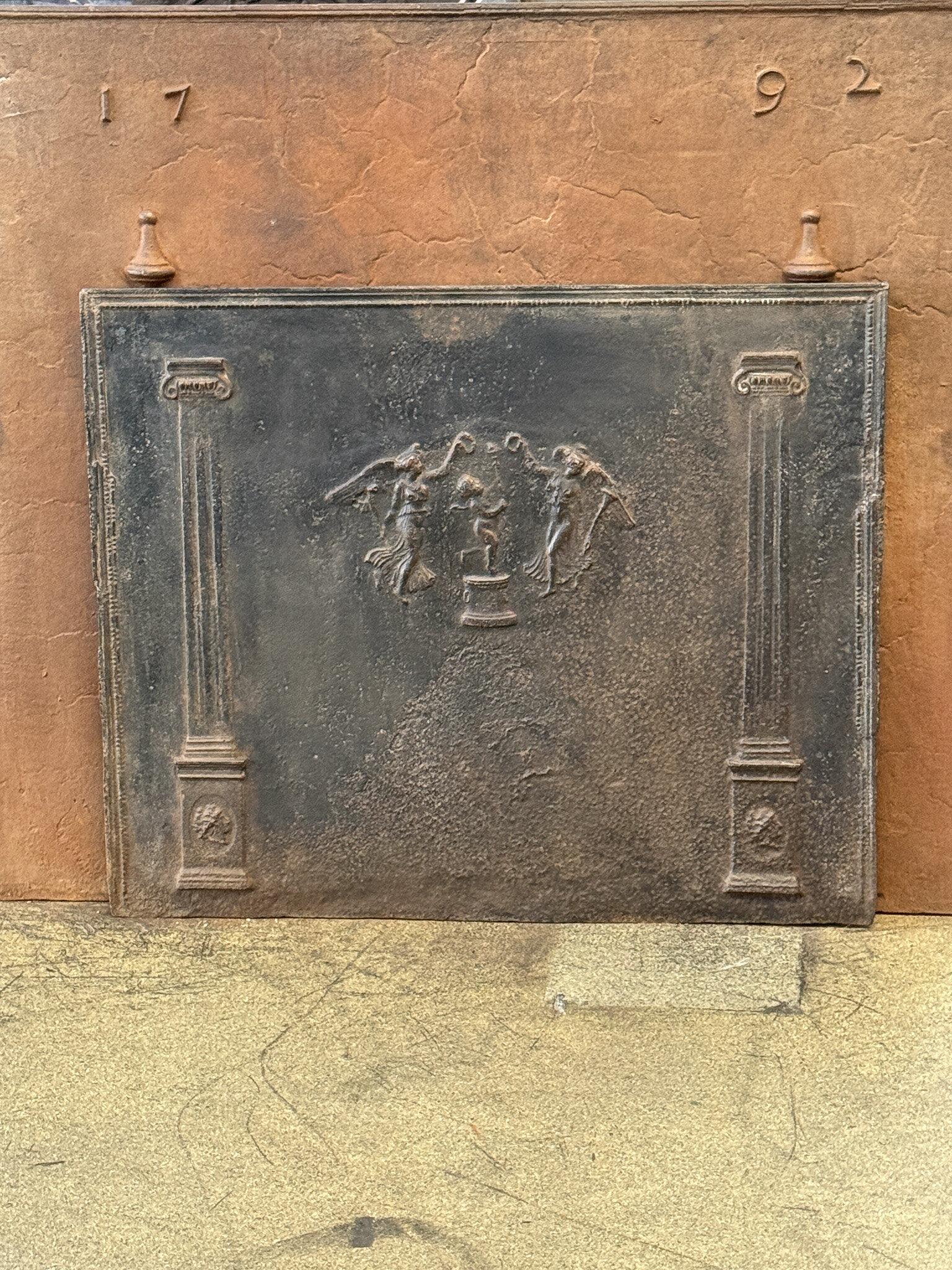 Early 19th century French neoclassical fireback with a cupid and two dancing angels. 

The fireback is made of cast iron and has a natural brown patina. Upon request it can be made black / pewter at no extra cost. It is in a good condition and does
