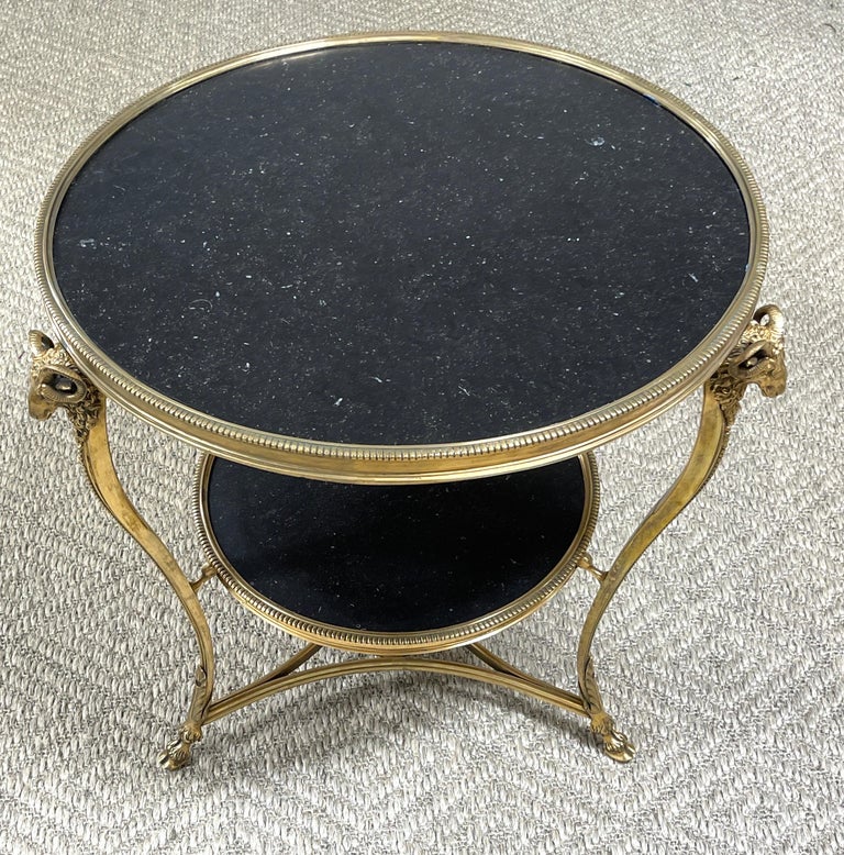 French Neoclassical gilt bronze rams head & black marble gueridon table
France, circa 1950s-60s.

A fine example, with superb gilt bronze casting, with inset circular black marble top, supported on a two tiered tripartite pedestal base with rams