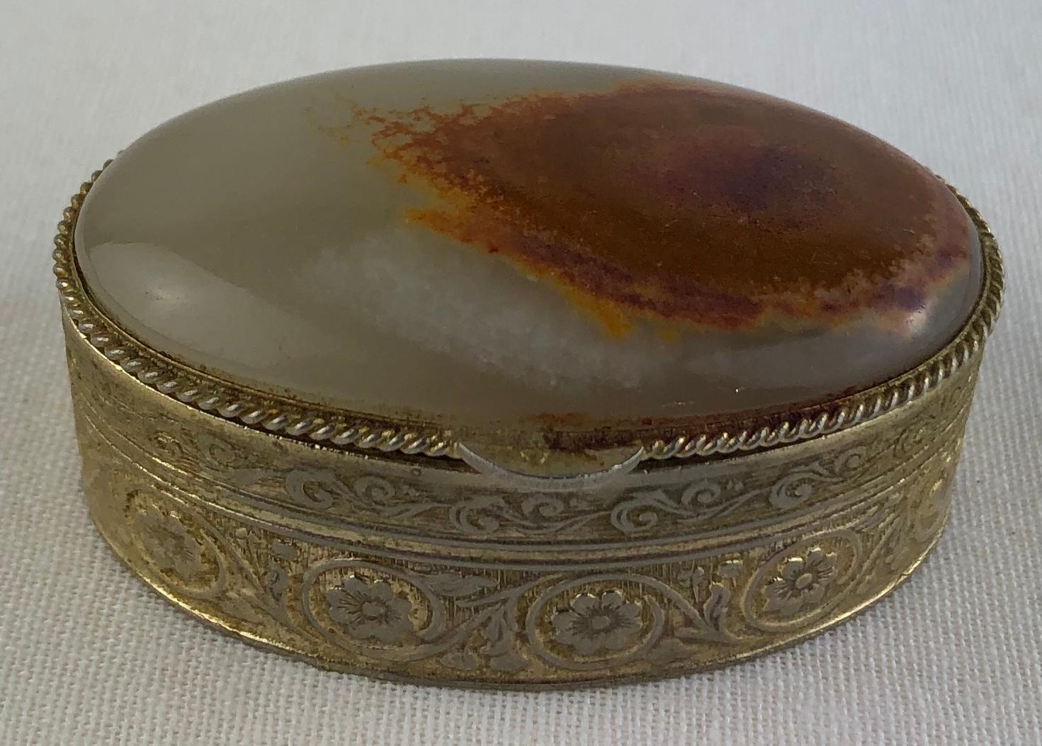 Beautiful handcrafted lidded pill, trinket, or small jewelry box. 
Intricately designed brass bottom, amber and quartz top. 

Makes a lovely gift to oneself or others.
Measures: 2