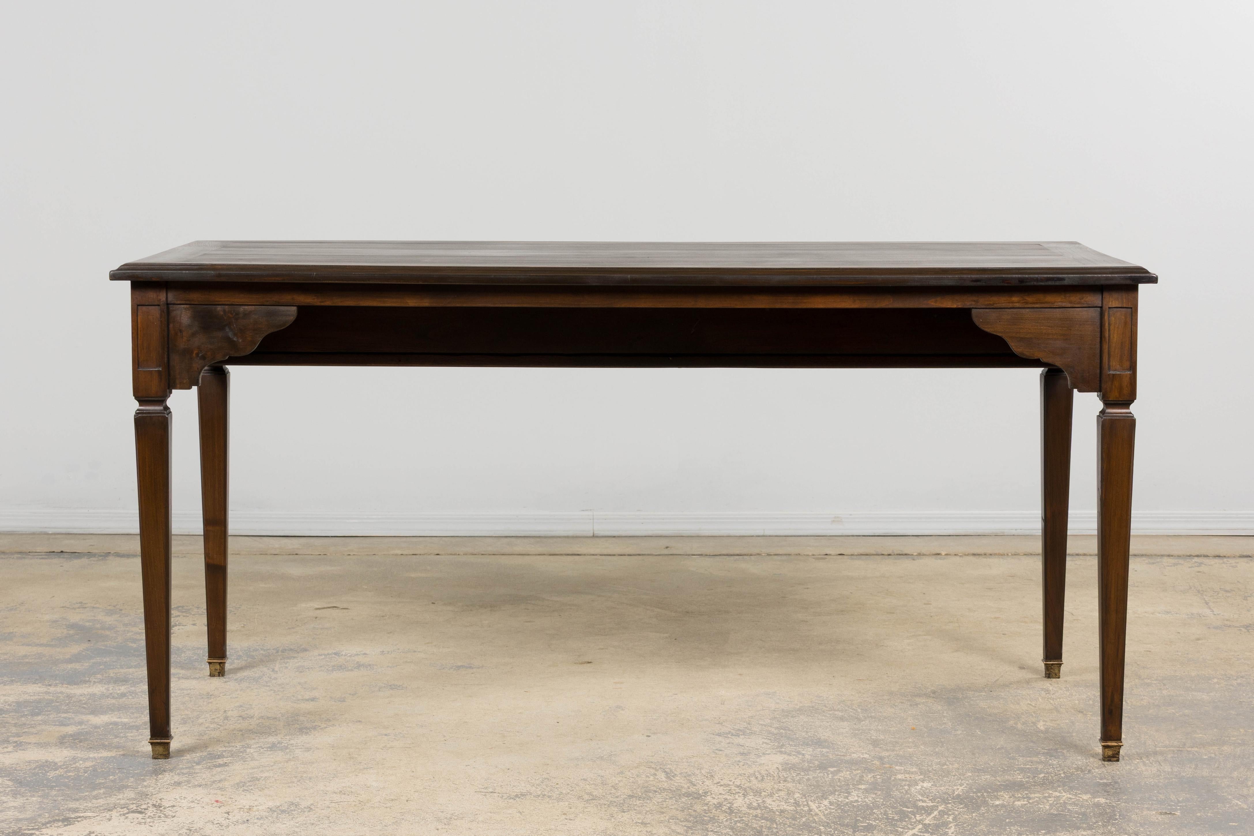 Un bureau plat français de style Louis XVI, fabriqué en érable massif et provenant de Provence, France. Le plateau rectangulaire est encadré d'un bord mouluré et biseauté. Il a été reverni dans un riche ton brun foncé qui fait ressortir le grain et