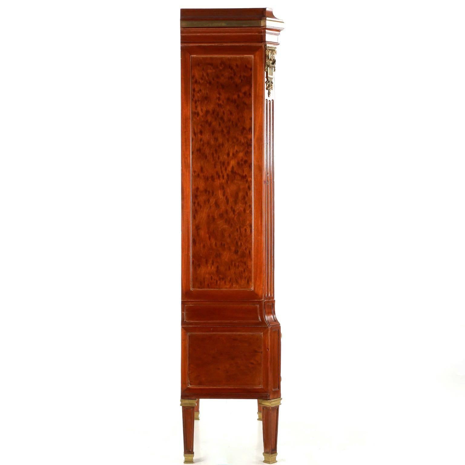 A most unusual and incredibly striking object, this tall case is designed in the Louis XVI taste with a distinct flair of the Neoclassical evident in its angular form. The facade is evenly distributed with perfect symmetry in the rectangular