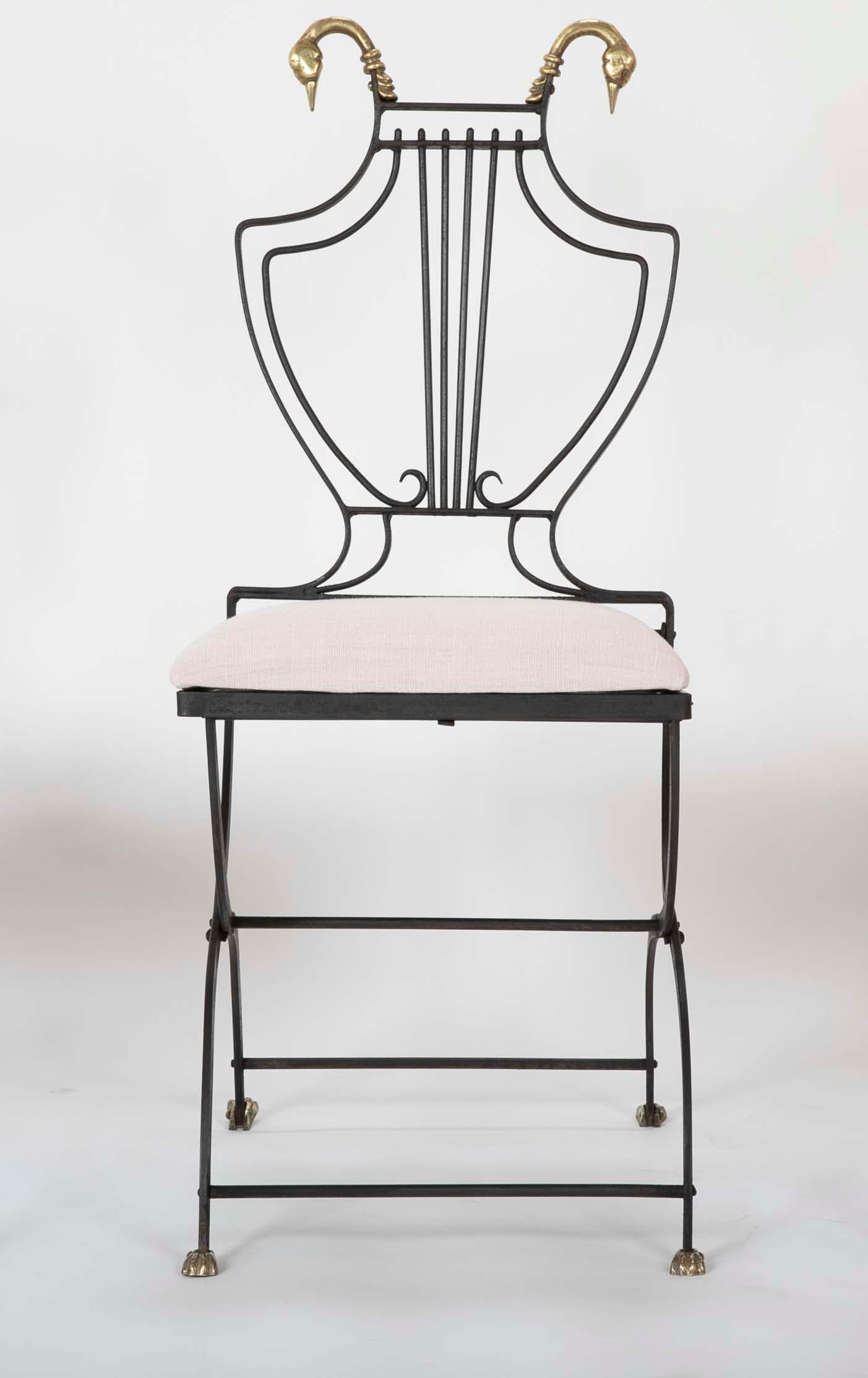 1950's French neoclassical Maison Jansen style lyre backed folding iron side chair with bronze swan finials and paw feet and upholstered seat. This Classic form is the height of elegance and can be used inside or out on the patio. Very sturdy and