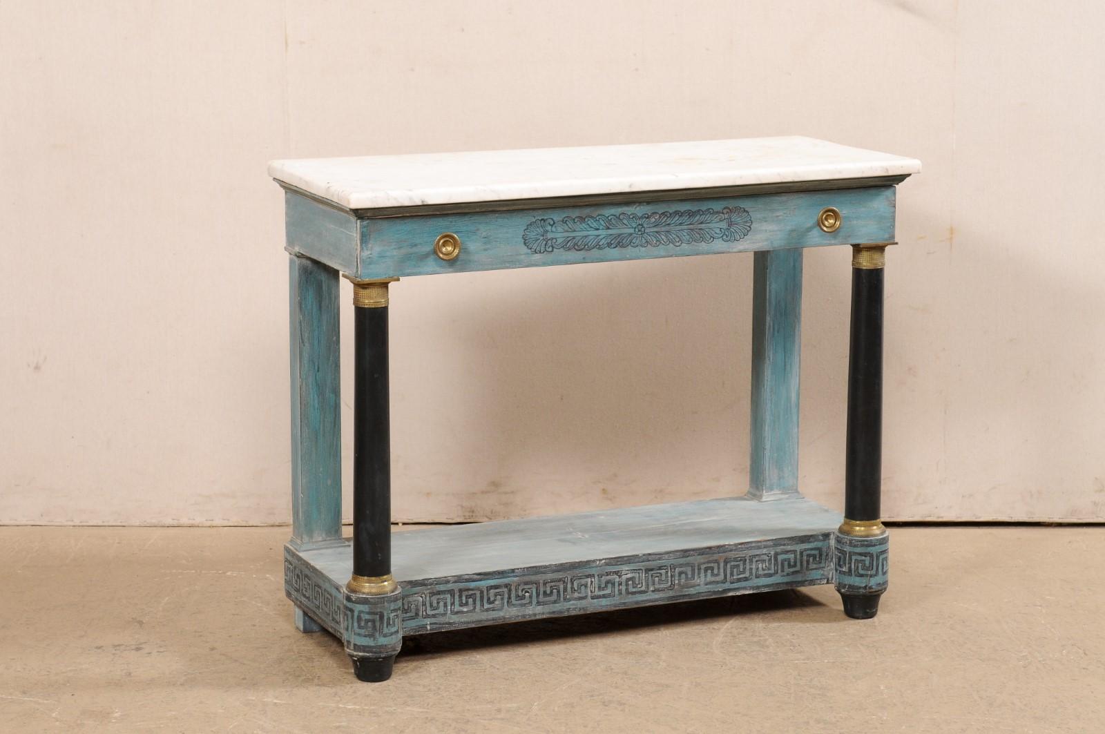 A French Neoclassical style painted wood console table, with marble top and Greek key motif, from the late 19th century. This antique table from France has been designed in neo-classical style, and features its original rectangular-shaped white