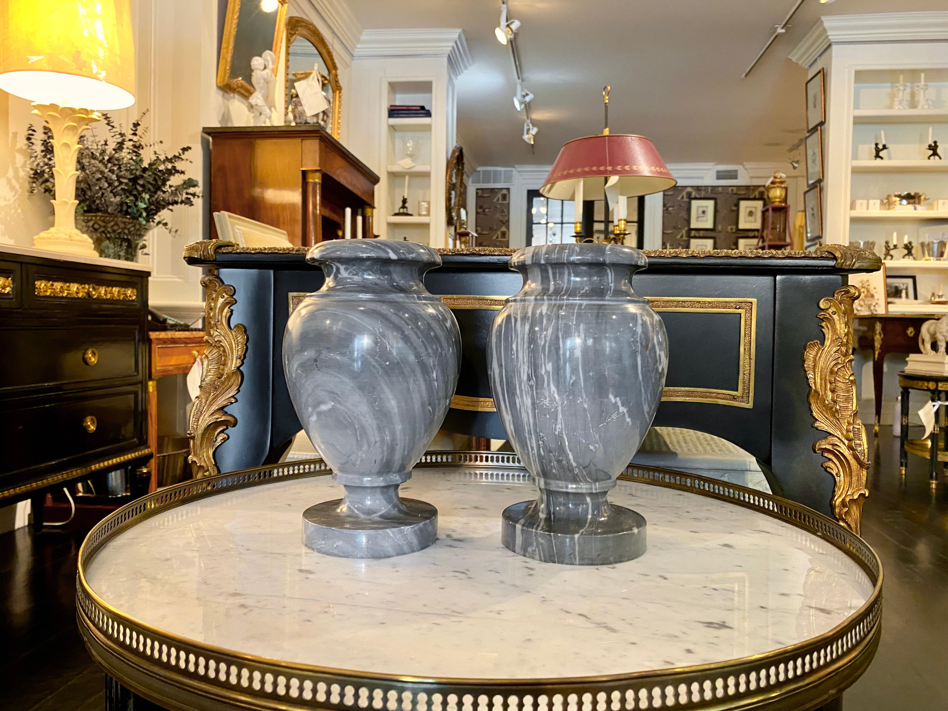 French neoclassical pair of grey marble urns, 20th century
Beautiful and highly decorative pair of white veined, grey marble urns.
Dimensions: 6 in. D x 9.75 in. H.