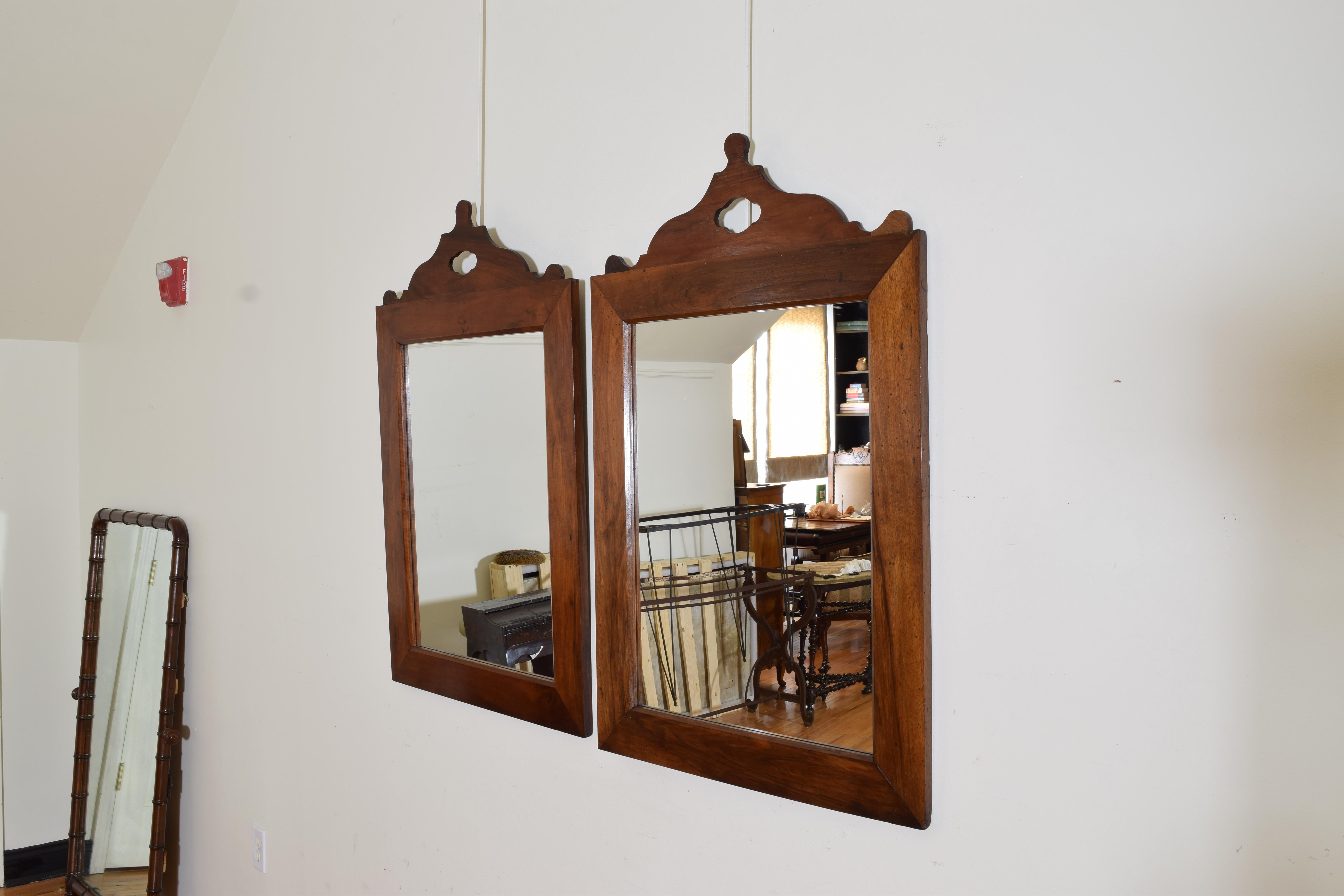 French Neoclassical Period Pair Shaped Walnut Mirrors, 2nd quarter 19th century In Good Condition For Sale In Atlanta, GA