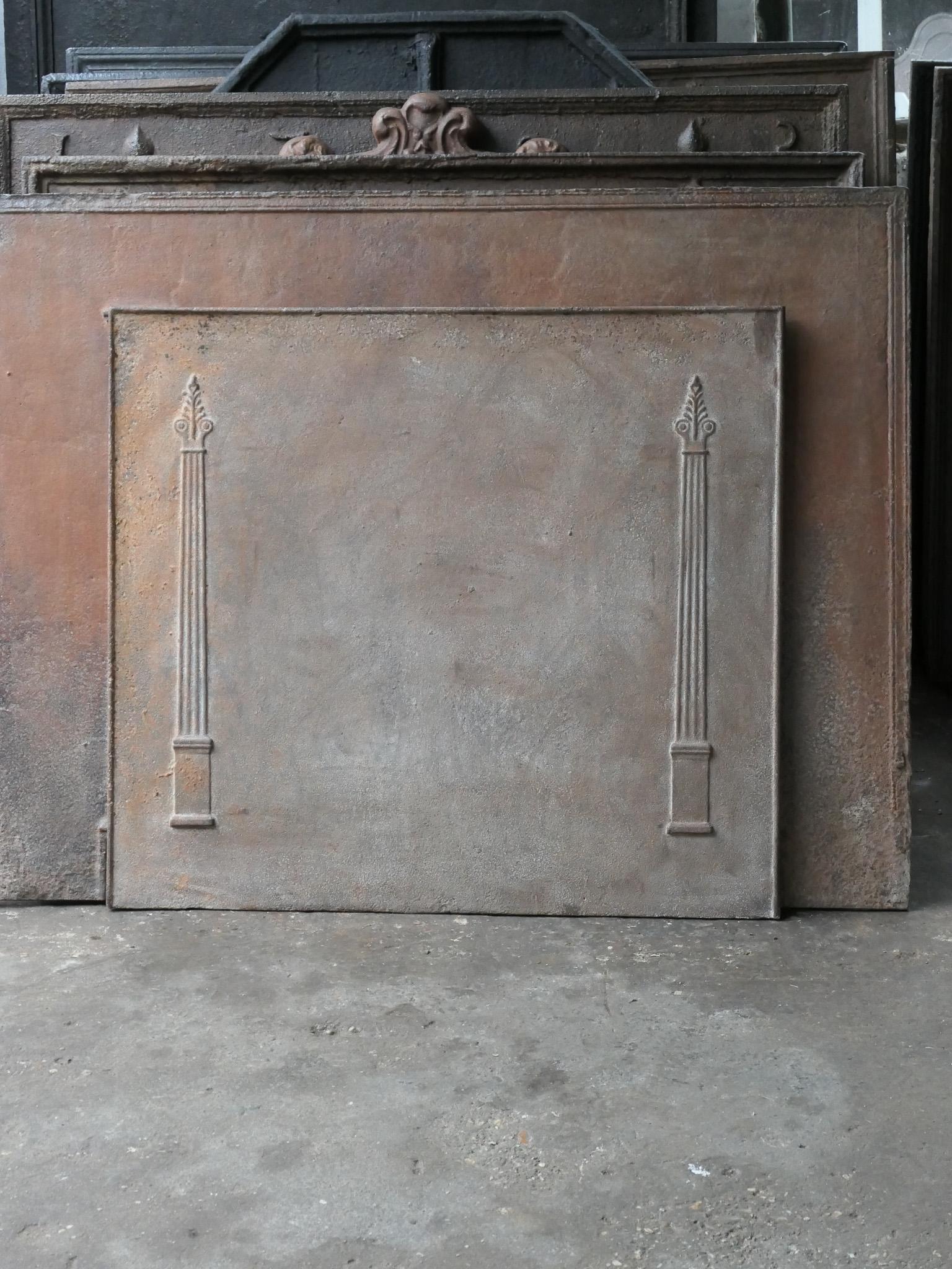 19th Century French Neoclassical fireback with two pillars of freedom. The pillars symbolize the value liberty, one of the three values of the French revolution.

The fireback is made of cast iron and has a natural brown patina. Upon request it