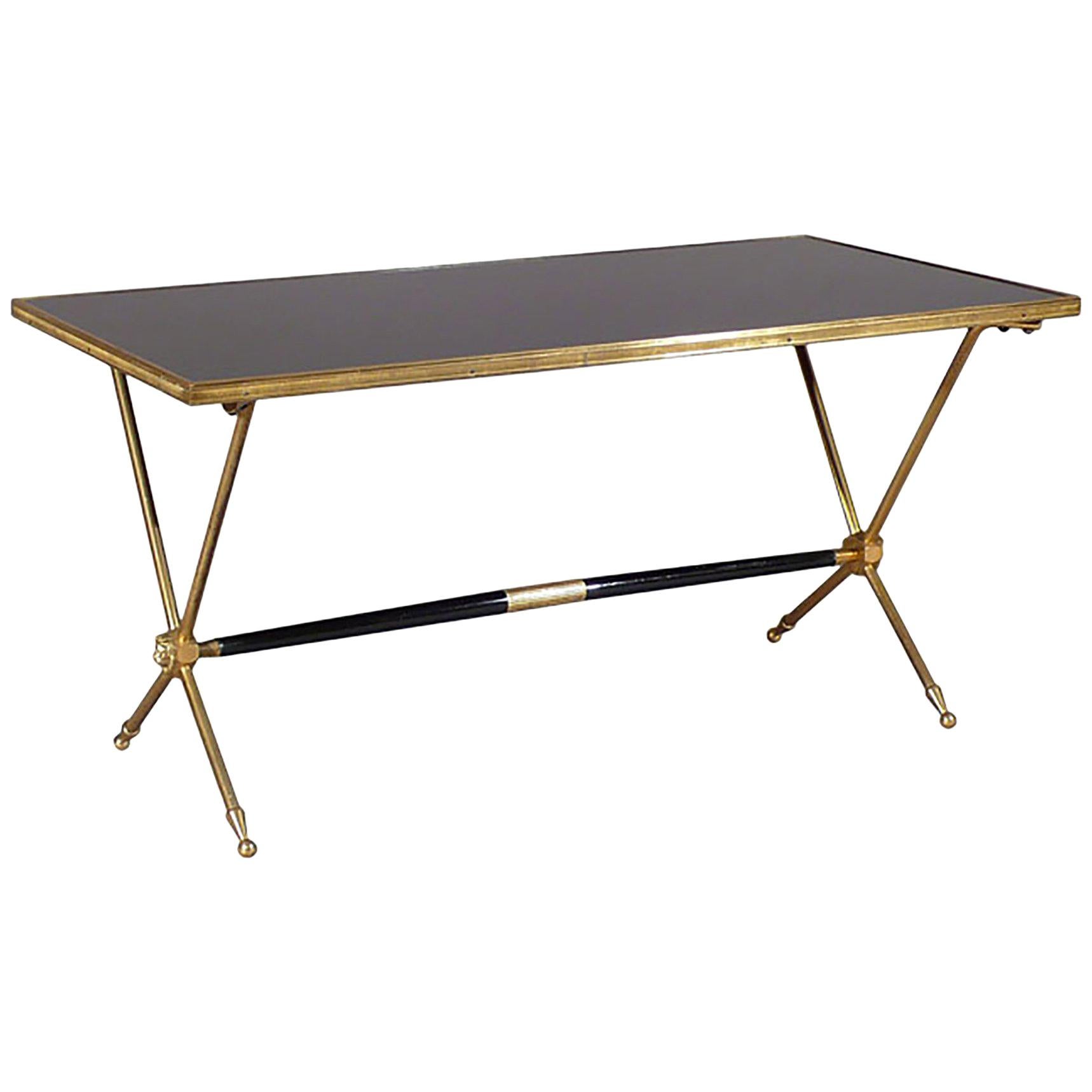 The black opaline surface of this coffee table appears reflective, calling to mind a still POOL of deep water, the result being a luxurious, timeless piece that, coupled with the intriguing brass lion head details, imbues any space with a sense of