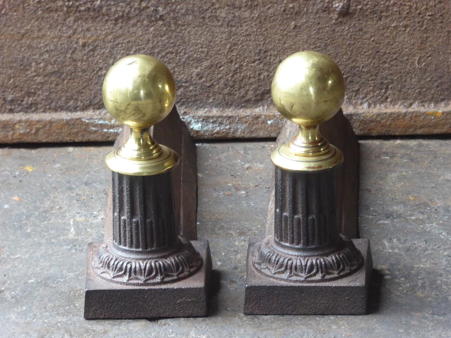19th-20th century French Neoclassical style andirons made of brass and cast iron.