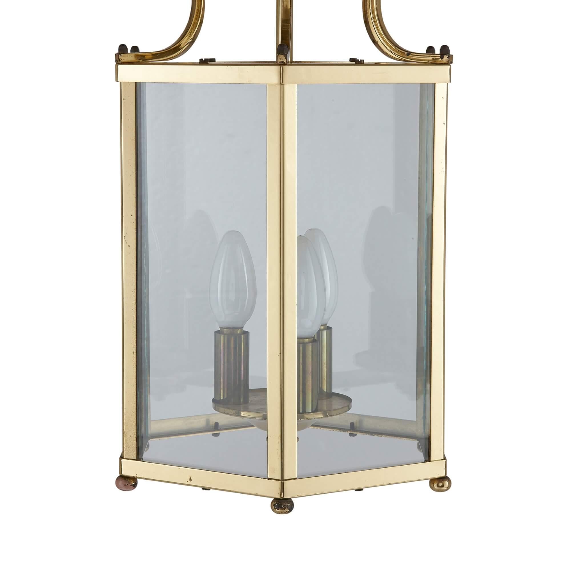 French Neoclassical style brass lantern
French, 20th century
Measures: height 58 cm, diameter 23cm

This fine hall lantern is crafted from brass in a classical style. The hexagonal lantern features six rectangular glazed sides, set within a