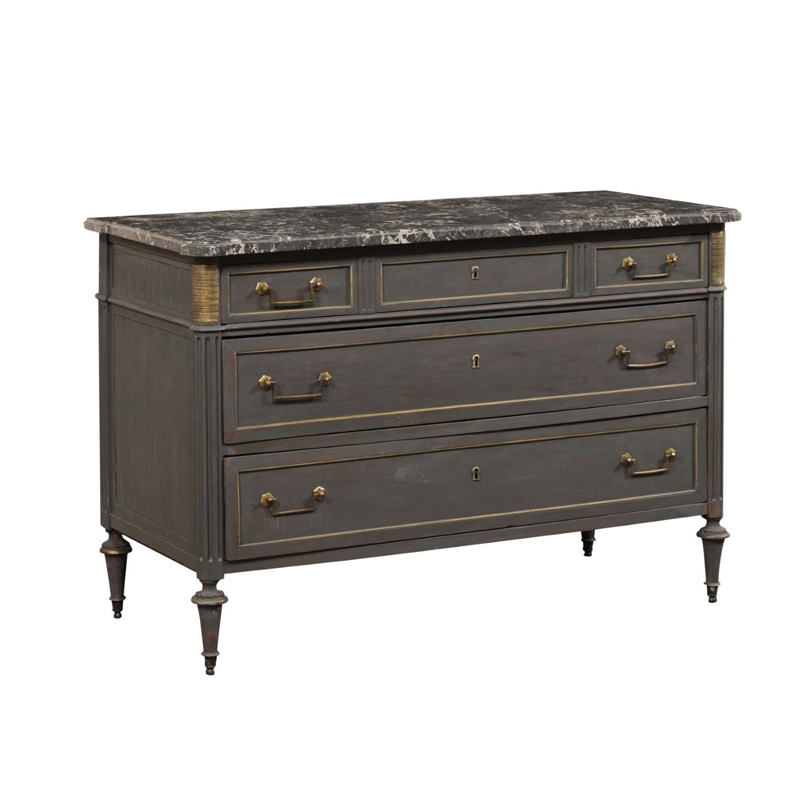 A French neoclassical style chest of drawers with marble top from the 19th century. This antique chest from France features a rectangular-shaped marble top, with pronounced rounded corners, which rests atop a neoclassical style case with rounded and