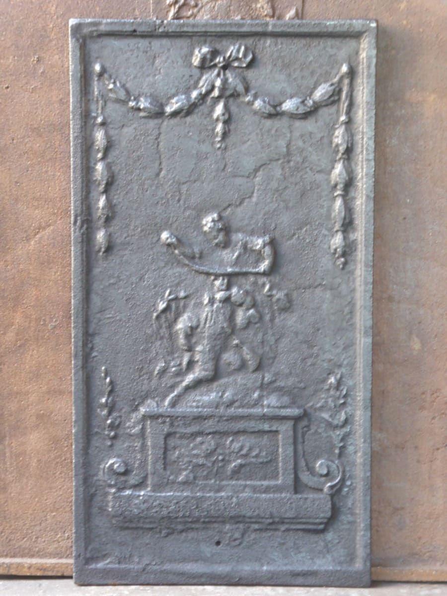 20th Century French Neoclassical Style Fireback / Backsplash

The fireback is made of cast iron and is black / pewter in color. It is in good condition and does not have cracks.