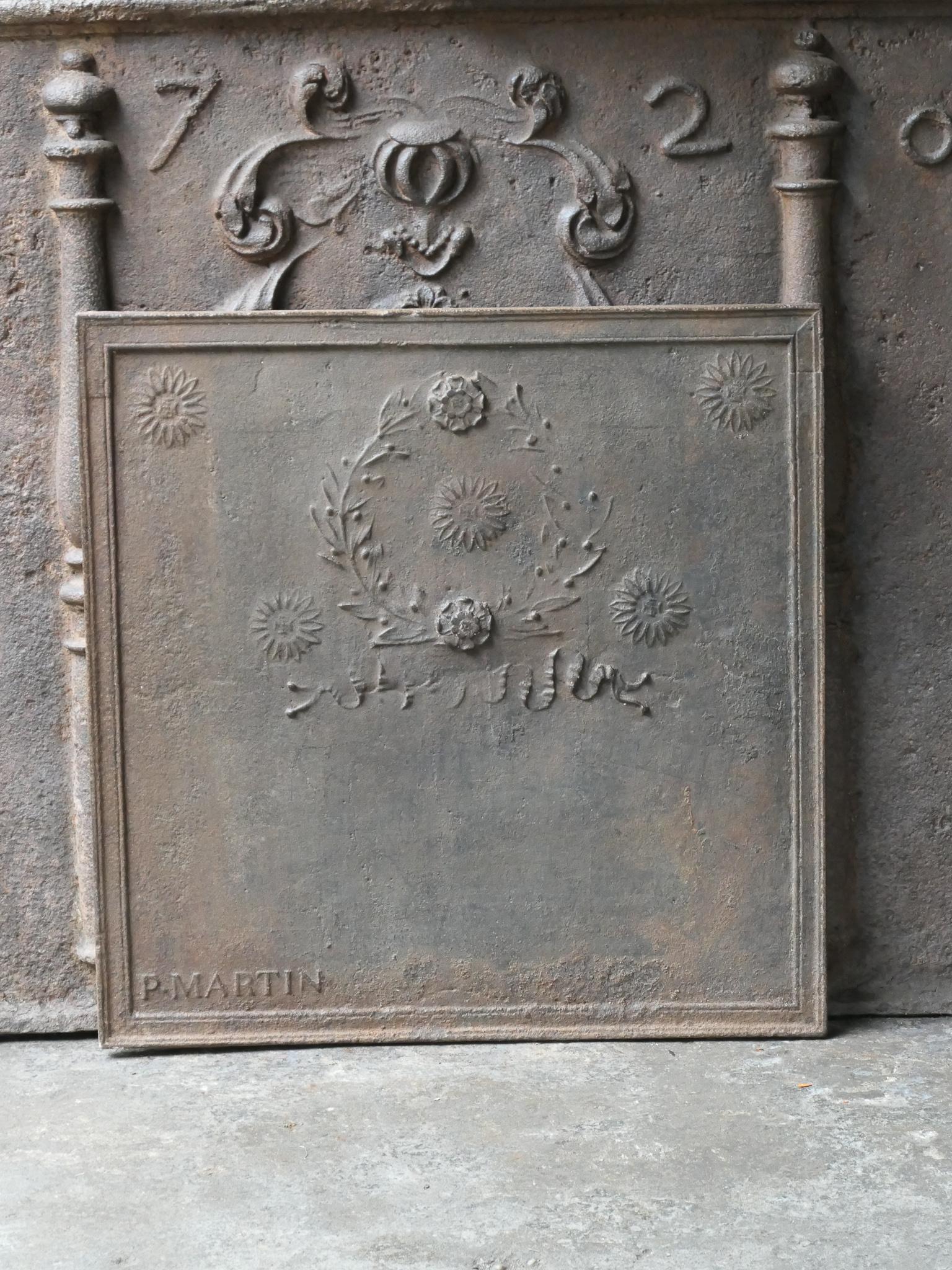 19th - 20th Century French Neoclassical Style fireback.

The fireback is made of cast iron and has a brown patina. Upon request it can be made black / pewter. It is in a good condition and does not have cracks.