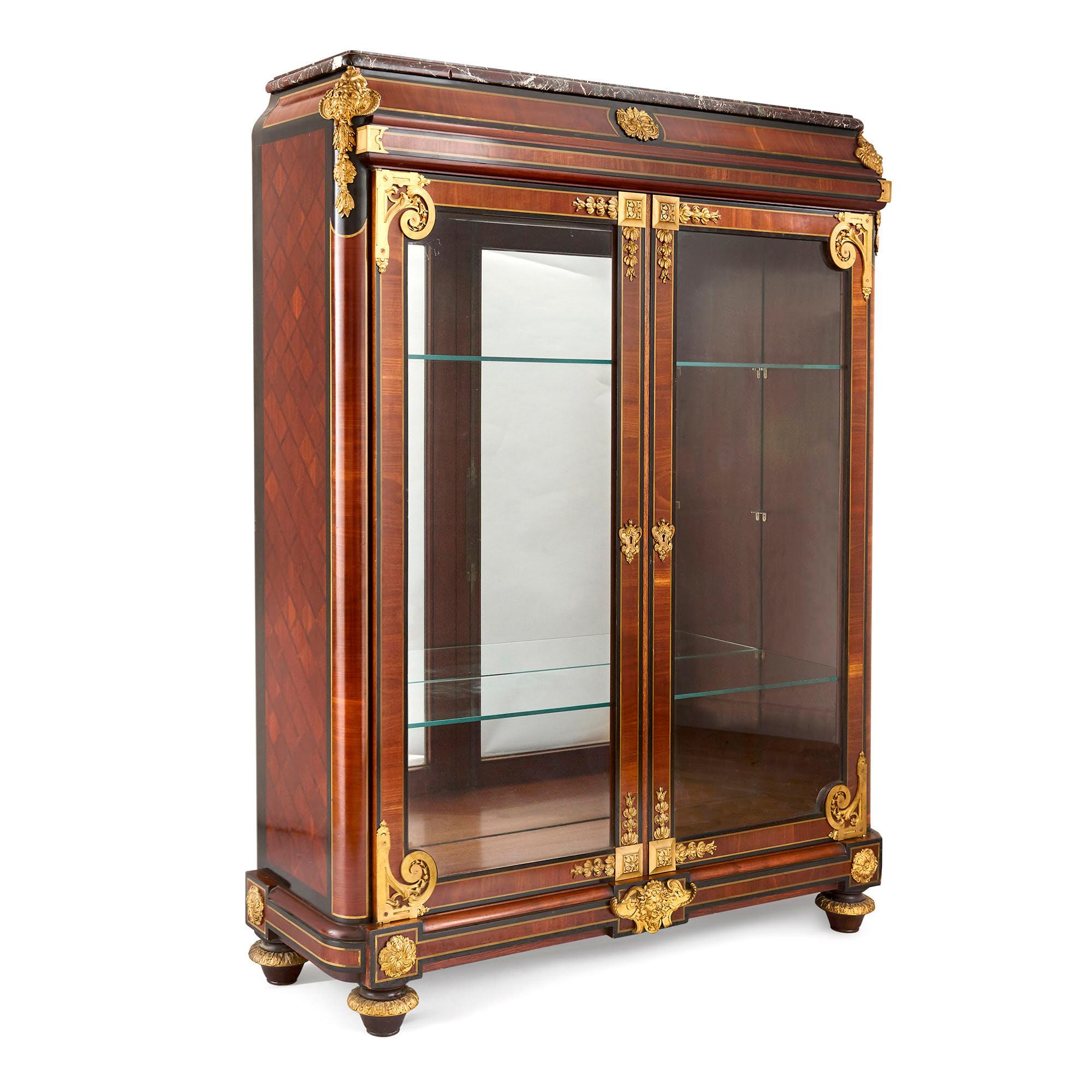 French neoclassical style gilt bronze mounted ebonized wood display cabinet
French, late 19th century
Measures: Height 164cm, width 122cm, depth 40cm

This fine display cabinet, attributed to Mercier Frères, is a superb example of the French