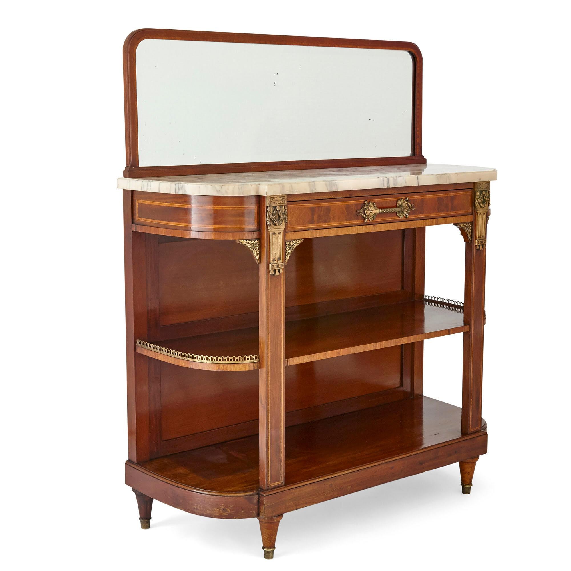 Crafted from mahogany inlaid with a variety of veneers, and mounted with beautiful gilt bronze, this Louis XVI style mirror-topped side table would make a beautiful addition to any room.

The table is inset with a Serravezza Breccia marble top,
