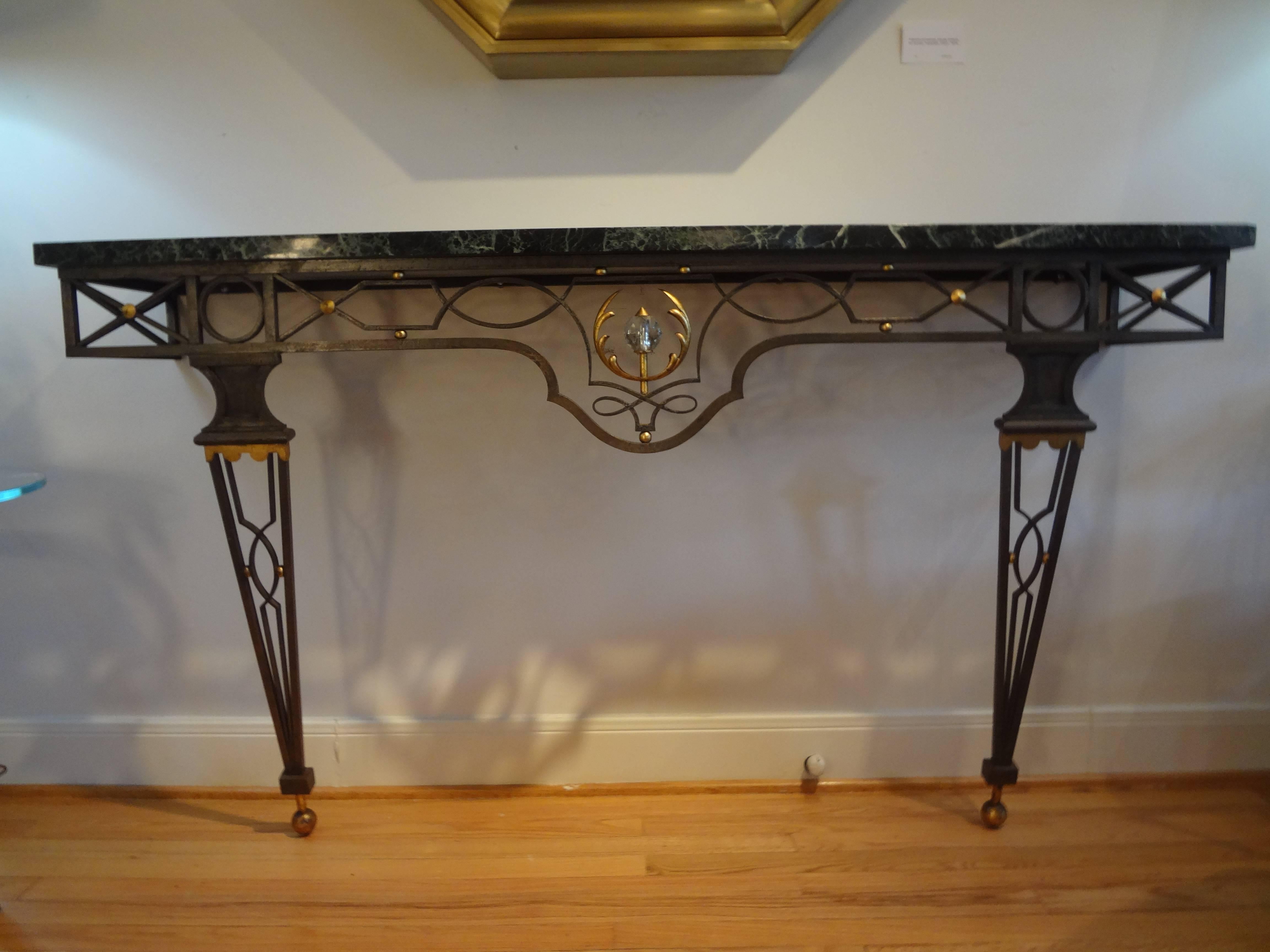 French neoclassical style wrought iron console table after Gilbert Poillerat. This large outstanding large French Neoclassical style wrought iron console table inspired by Gilbert Poillerat, 1940s.
This stunning large French console is wall-mounted