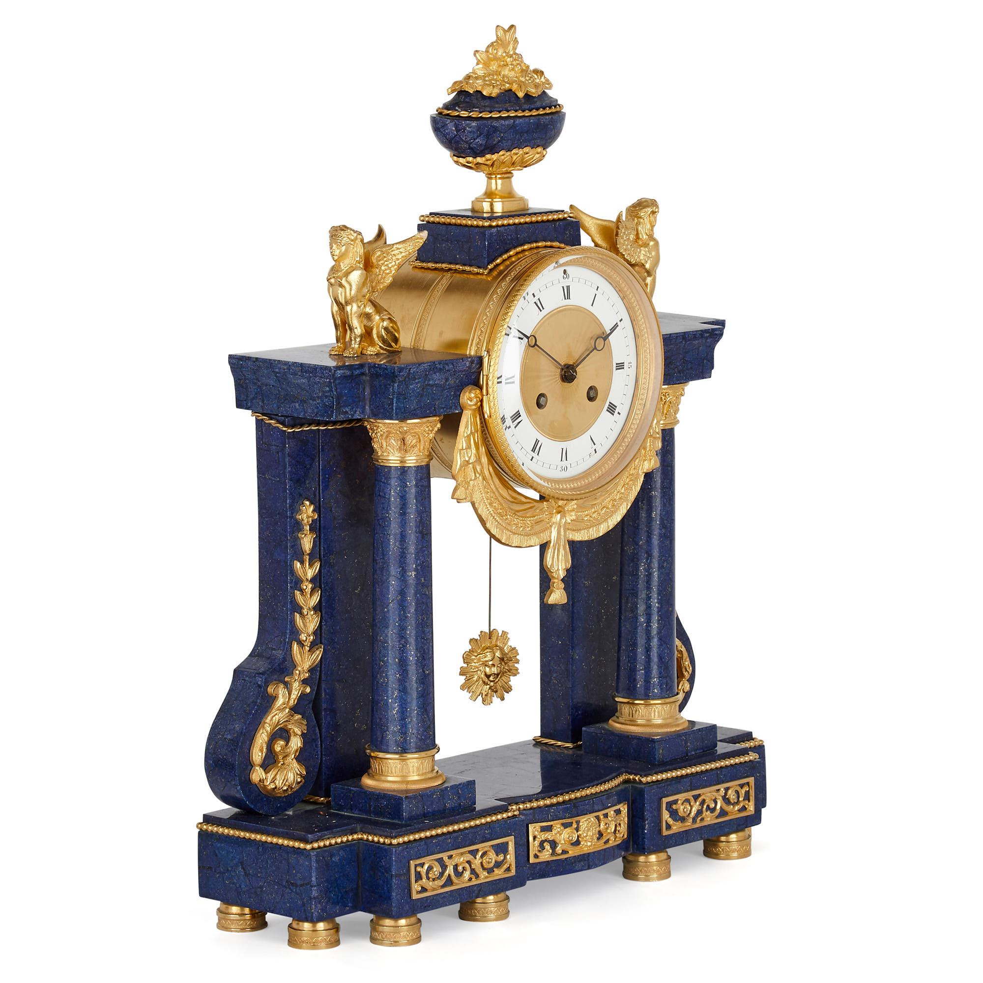 French neoclassical style lapis and gilt bronze clock set
French, late 19th century
Clock height 52cm, width 39cm, depth 15cm 
Vases height 38cm, width 16cm, depth 12cm

This beautiful neoclassical style clock set, comprised of a mantel clock