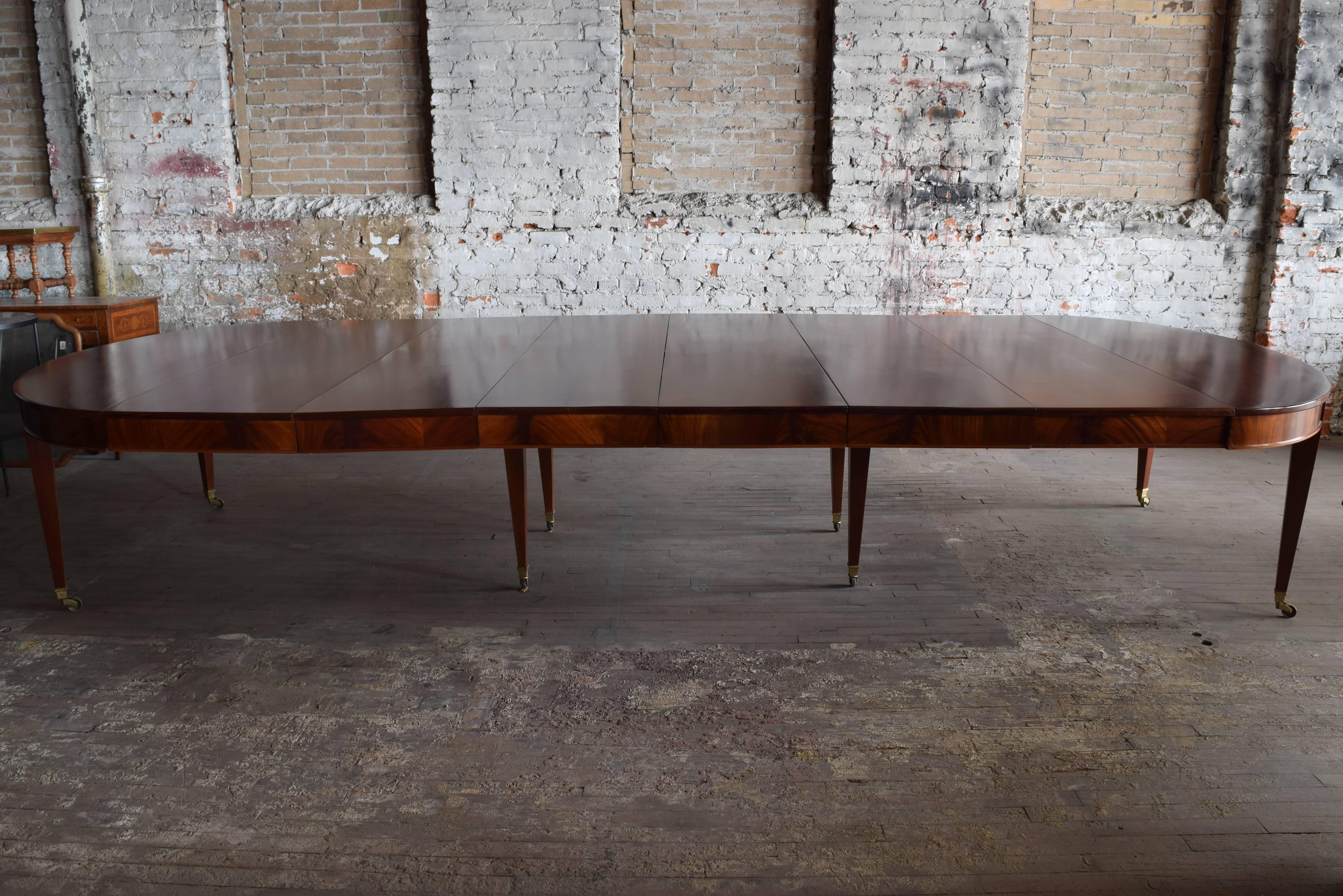 Of sizable depth and length, the table and 6 leaves all having full aprons, raised on square tapering legs ending in original brass casters, width of leaves are four at 19.5