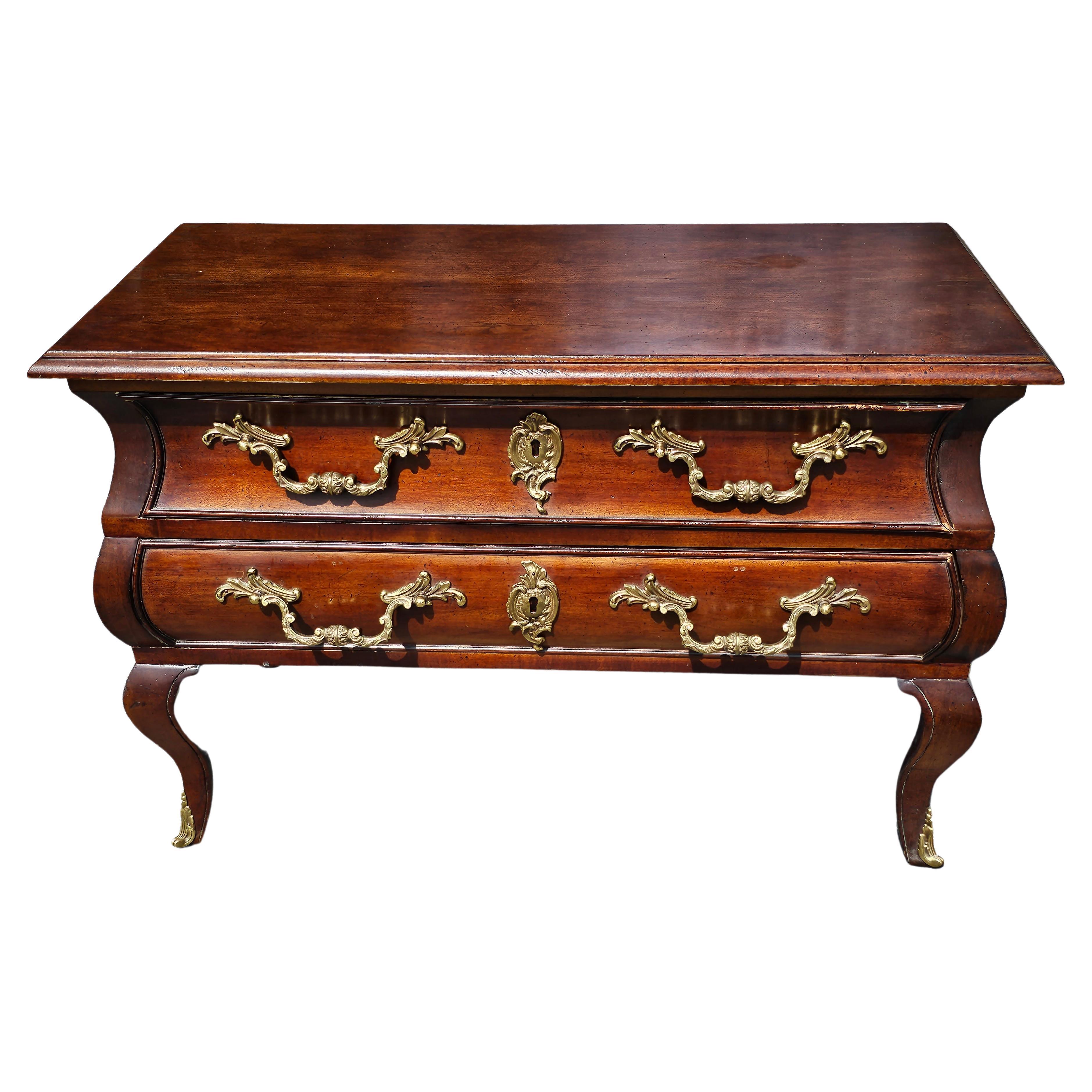 An exquisite two drawer French Neoclassical Style Mahogany Brass Mounted Low Chest  or Commode in goof vintage condition. Rare french handles and smooth drawers. Measures 33