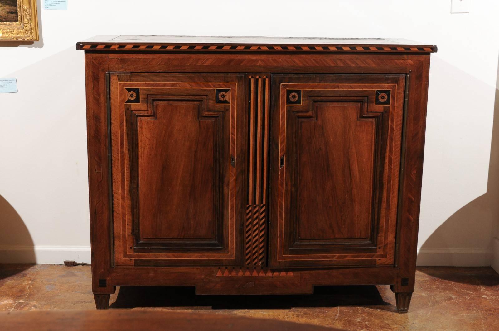 A French neoclassical style mahogany buffet from the mid-19th century, with marquetry inlay. This exquisite French two-door buffet features a rectangular top showing beautiful signs of aging, adorned in the front with a delicate two-toned inlay and