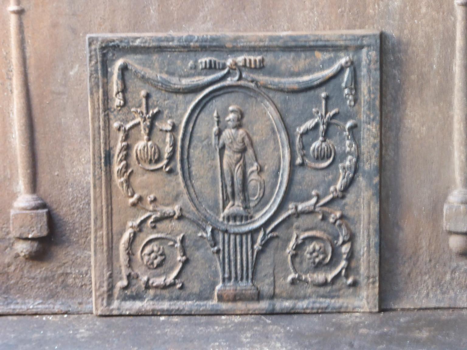 French fireback with the goddess Minerva. Goddess of knowledge, intellect and ingenuity of the human spirit. She is often depicted with an owl, symbol of wisdom. The 20th century fireback has a neoclassical style. The fireback is made of cast iron