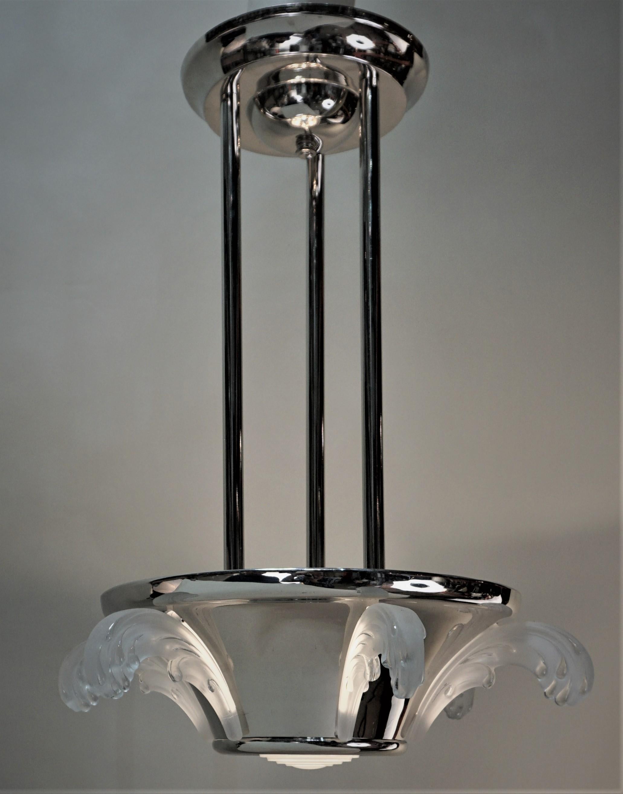 Polished nickel on bronze and feather design frost clear glass Art Deco chandelier.