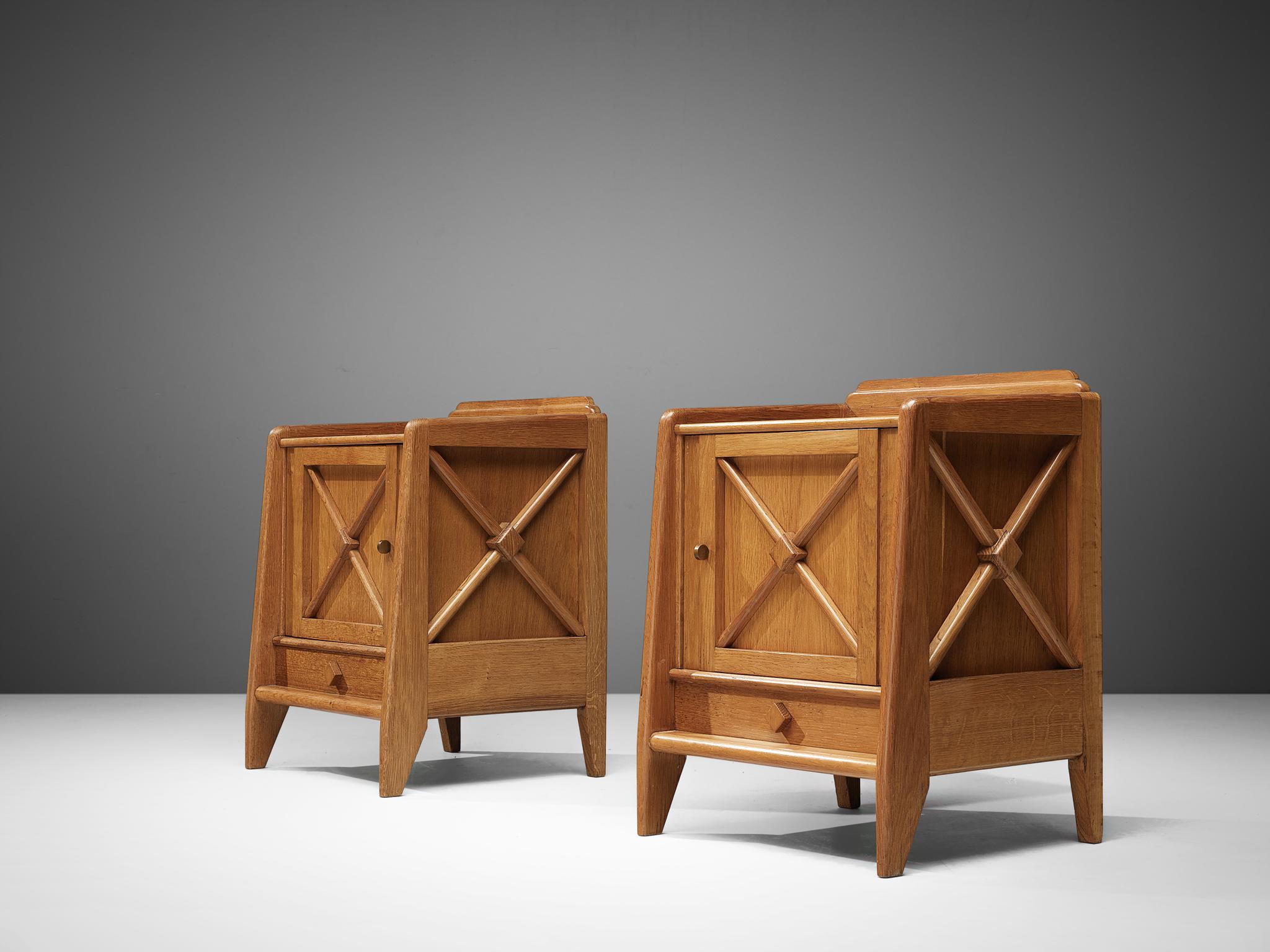 Nightstands, oak, France, 1960s.

Elegant night stands in oak that feature geometric details in the doors. The nightstands are lifted from the ground by slim, conical legs that give the solid looking body a more airy appearance. The cabinet offers