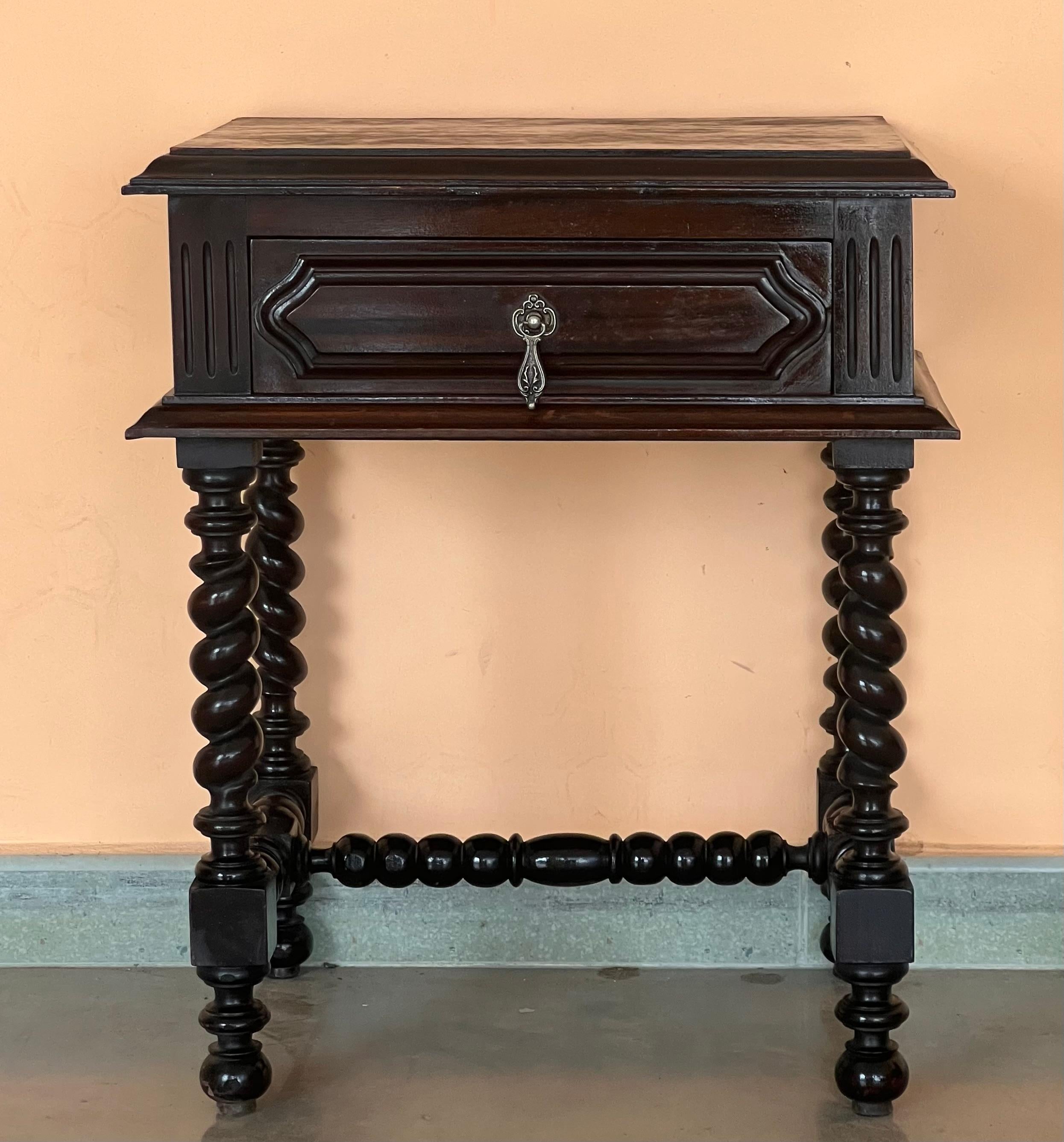 20th century pair of solid carved oak French nightstands with turned columns and stretcher.
It has one carved drawer with foliate reliefs and original hardware.