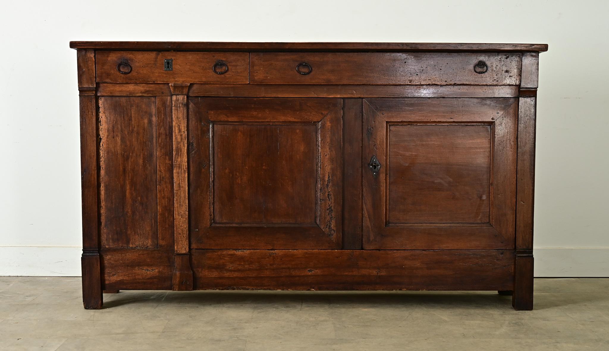 This French oak enfilade from circa 1830 brings substantial presence to anchor any room within a narrow footprint. Transitional, modest in style–ommitting the brass and bronze visual codes of the period–the buffet favors clean lines to allow the
