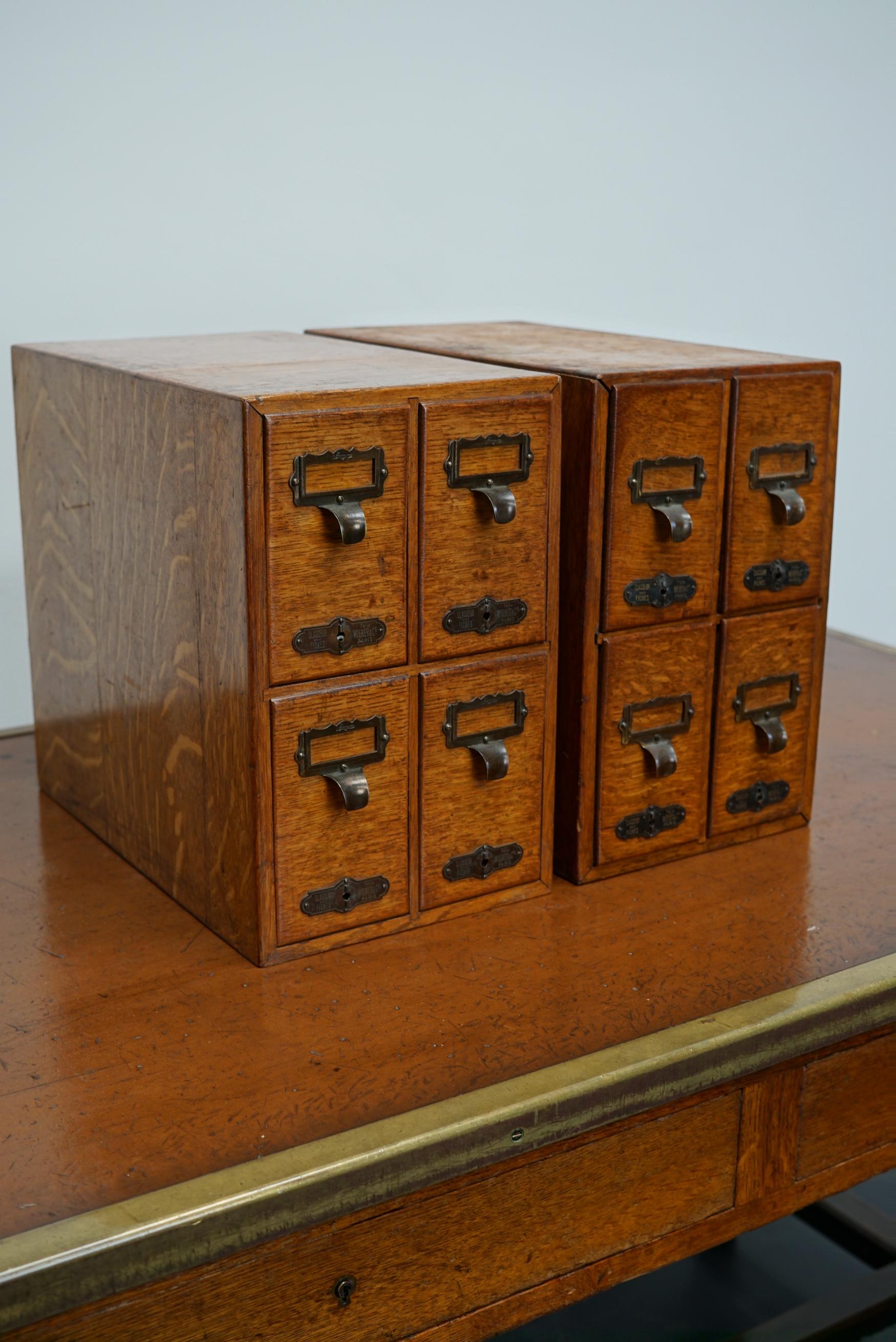 Very nice pair of small French oak filing cabinets with brass hardware made in Paris in the early 20th century. It is very well made and in a good antique condition. The interior dimension of the drawers are: D W H 29 x 7.5 x 7 / 13 cm.