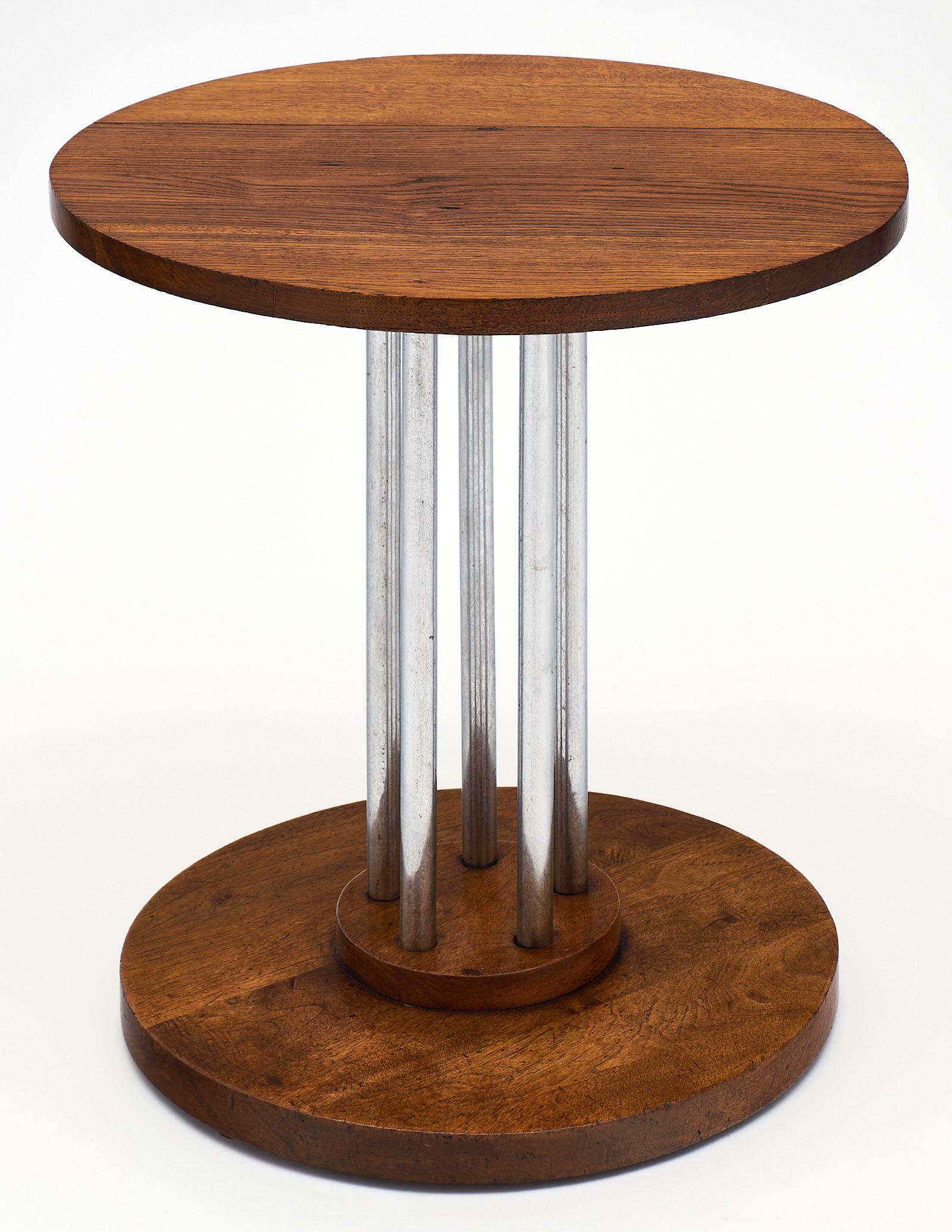 French architectural oak gueridon featuring a solid oak planked top and base connected with five chromed steel tubes. We loved the combination of the oak grain and modern chromed legs of the piece.