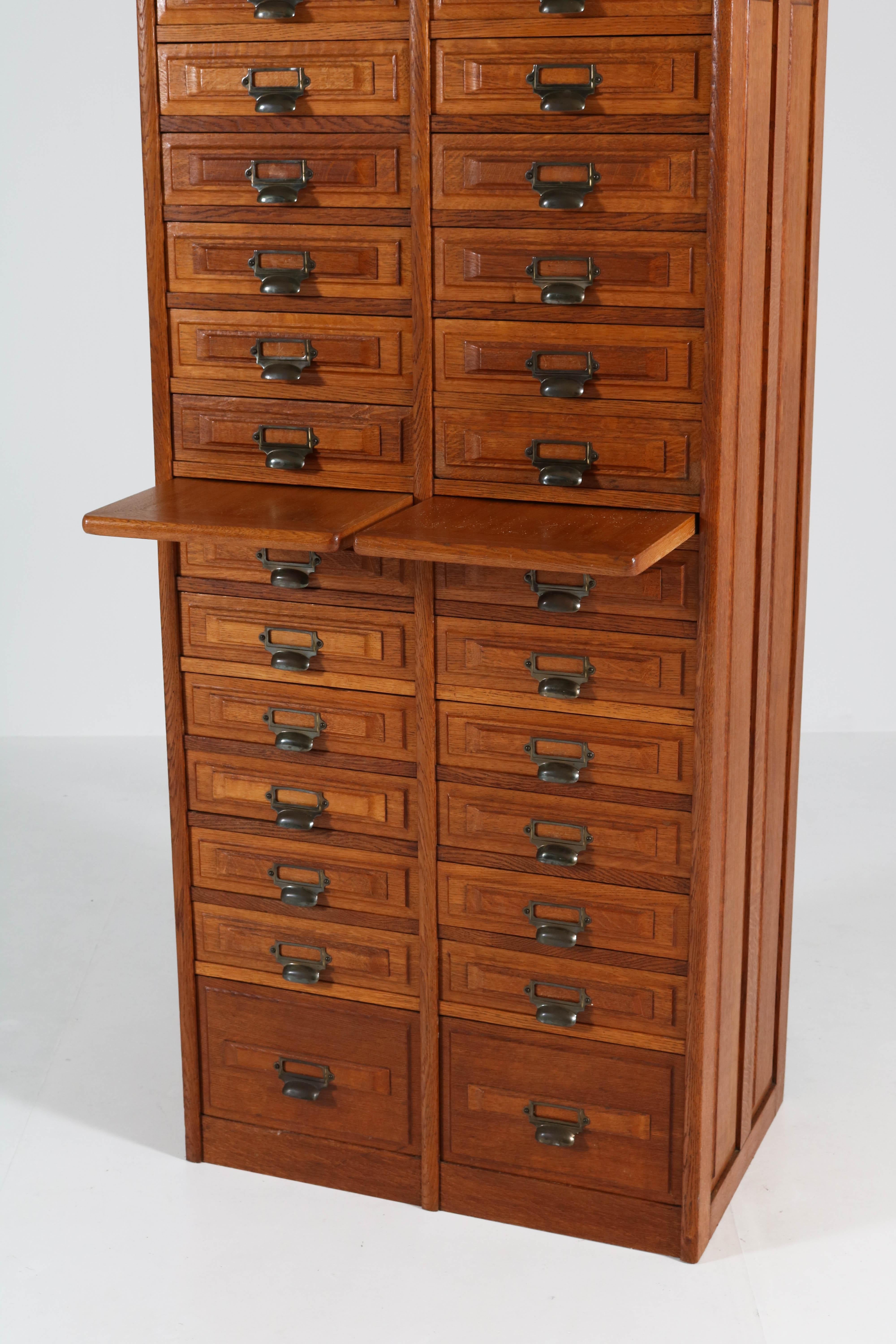 Stunning French Art Deco file cabinet, 1920s.
Solid oak with 26 original solid oak drawers.
In good original condition with minor wear consistent with age and use,
preserving a beautiful patina.
 