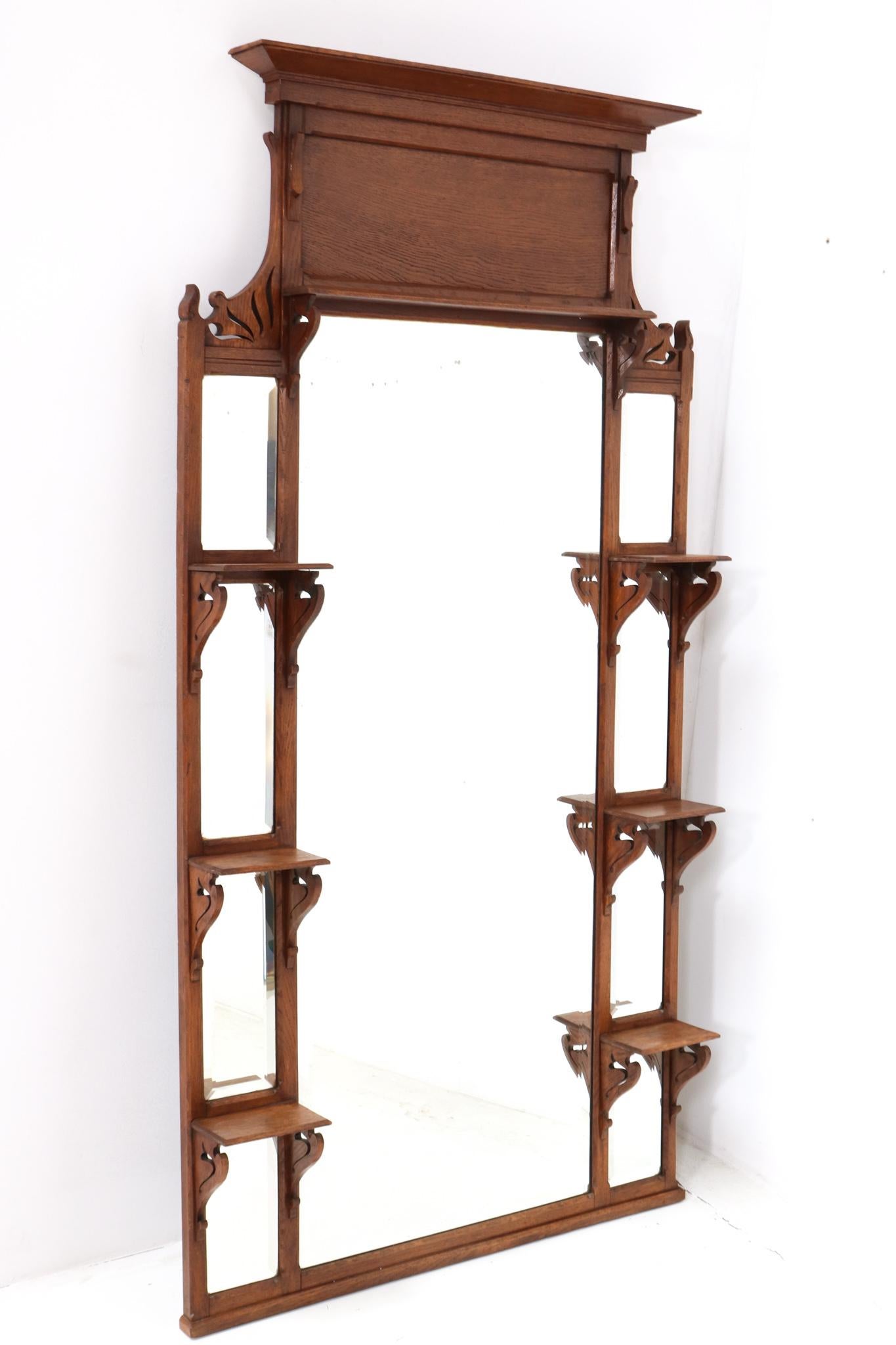 Magnificent and rare Art Nouveau trumeau or wall mirror.
Striking French design from the 1900s.
Solid oak frame with original beveled mirrored glass.
This wonderful Art Nouveau trumeau or wall mirror can also be used as
a display stand to put on