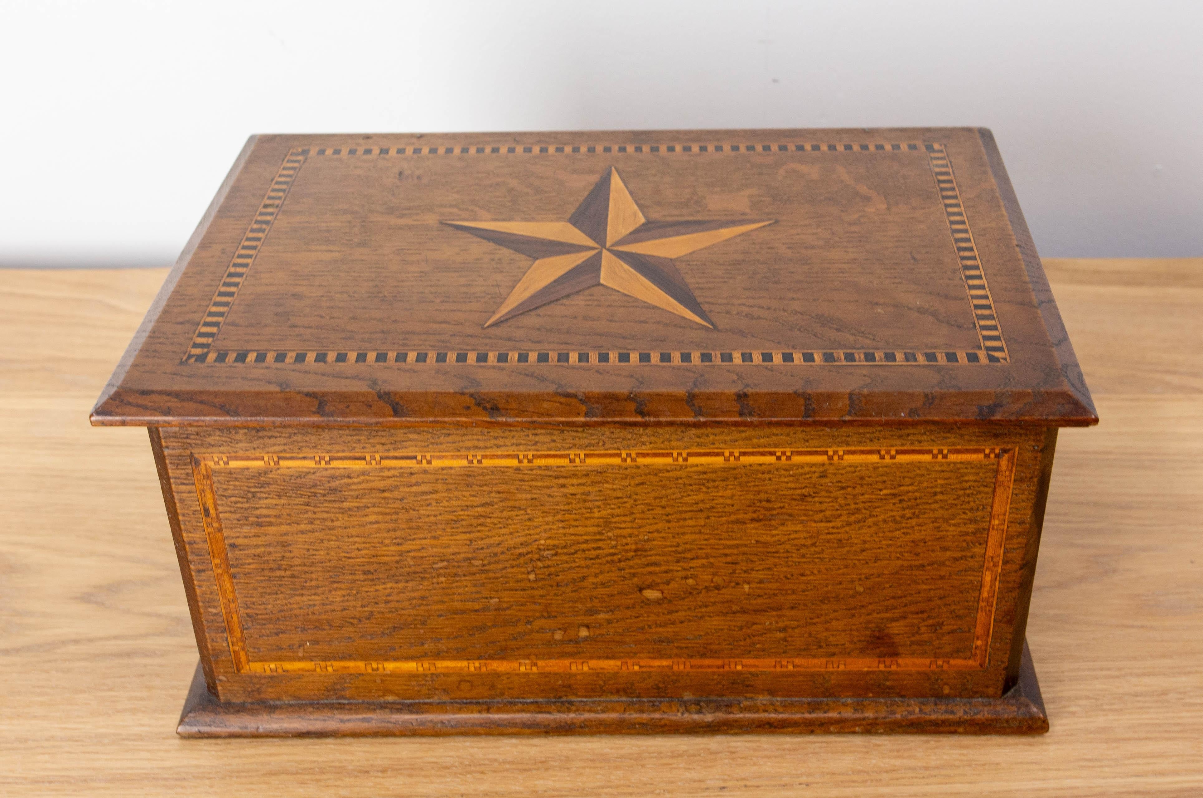 Coffret en bois français décoré d'une marqueterie comprenant une étoile sur le dessus.
Fabriqué vers 1920.
Bon état avec des traces d'eau sur les côtés.

Expédition :
21 / 32.5 / 15 cm 1.7 kg