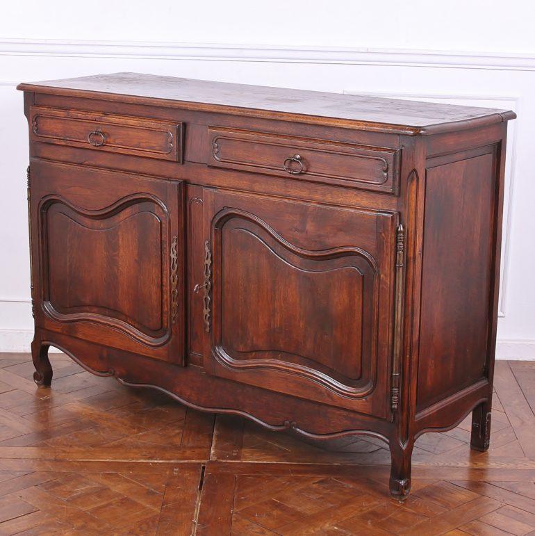 Early 20th century French oak buffet, with ample storage in two drawers and behind two lower cabinet doors. Solid oak frame-and-panel construction to the doors and sides and a solid oak top.



 