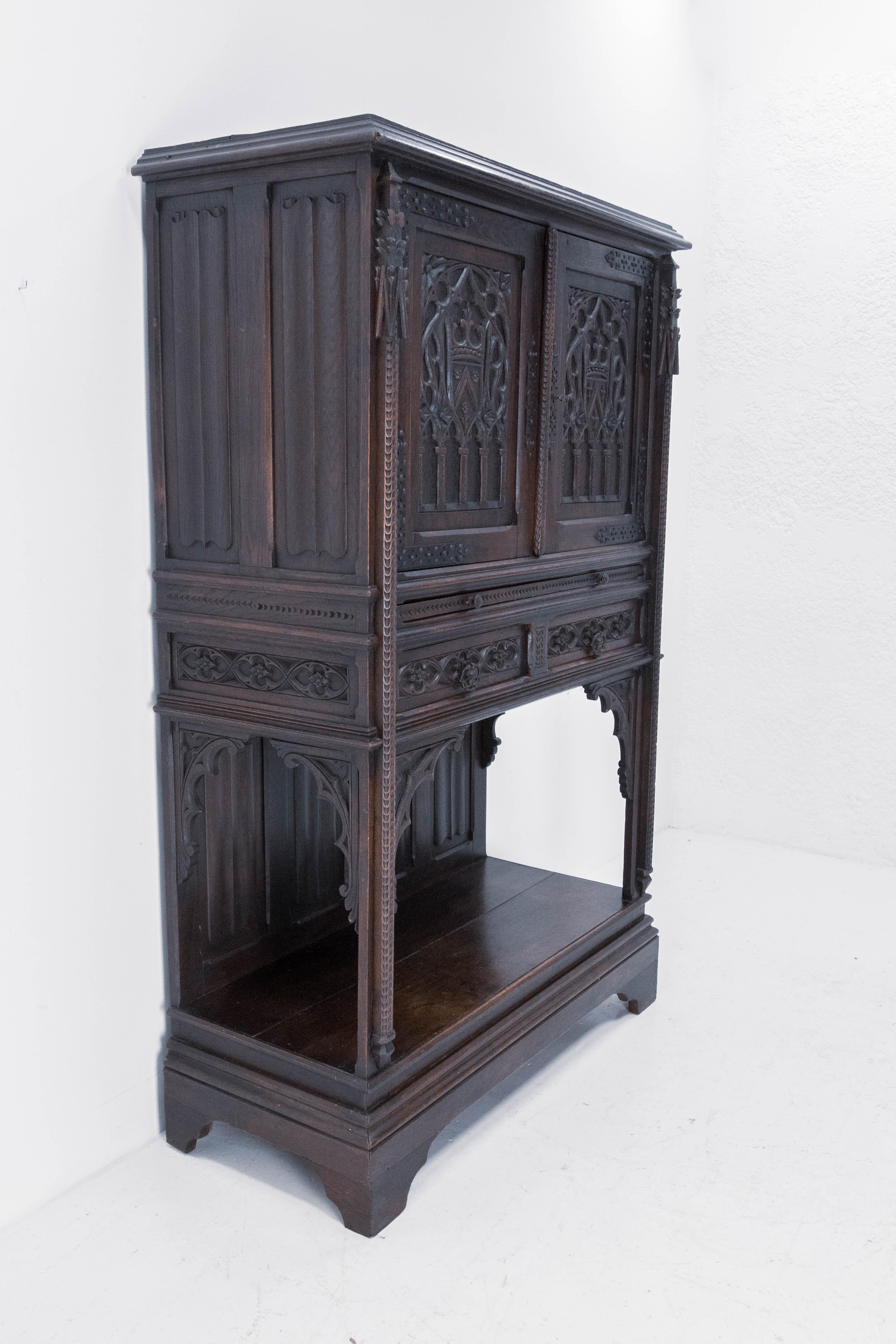 Buffet dressoir French cabinet, circa 1890
Two doors, two drawers, a retractable shelf
Height of the shelf 40.16 in. (107 cm)
Gothic Revival, solid oak
Nice patina
Good antique condition

Shipping: 
L116 P50.5 H180 72 kg.