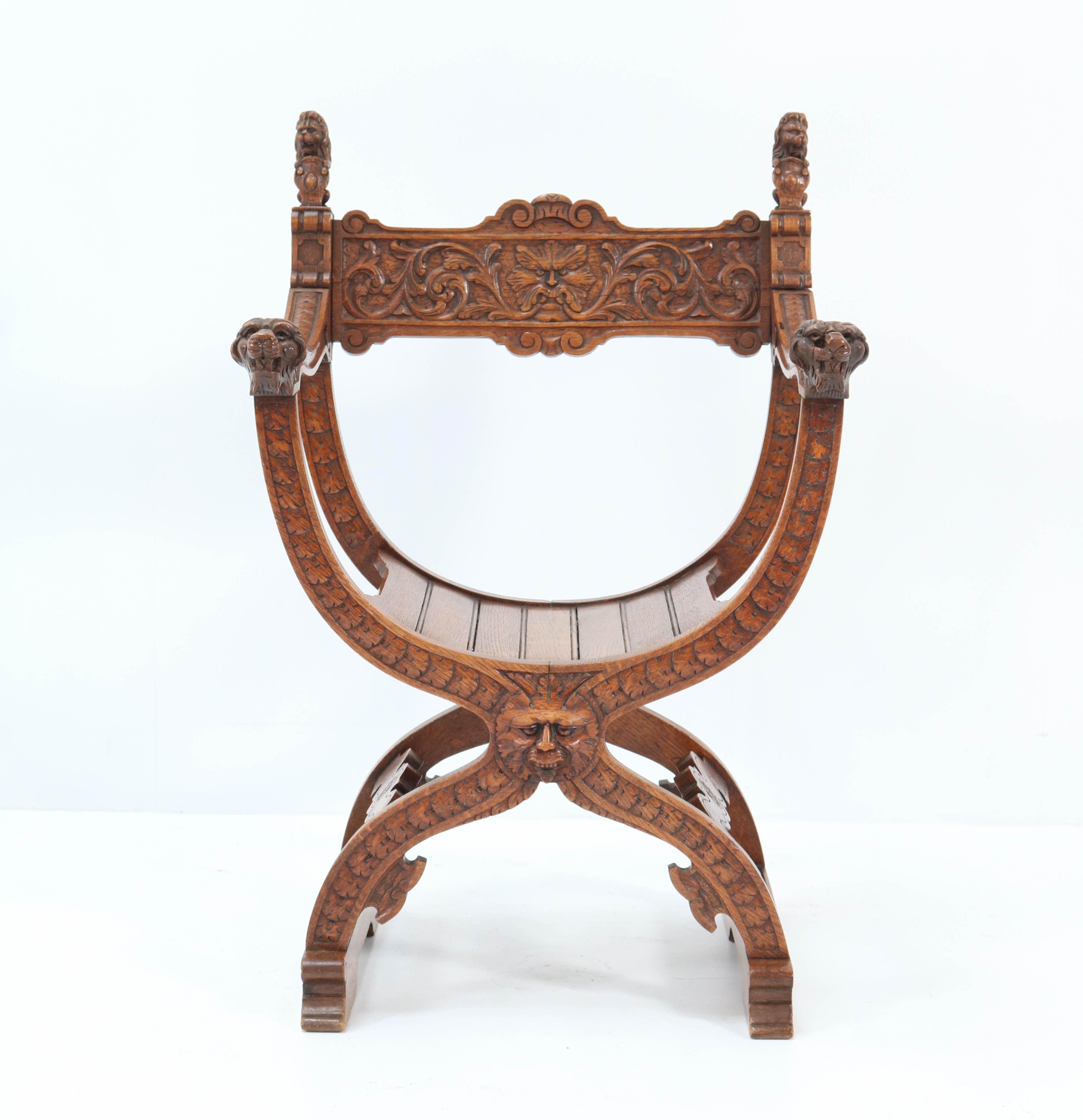 Stunning Neo Renaissance hand carved curule chair arm throne Dagobert.
Striking French design from the twenties.
Solid oak with solid oak curved slat seat.
In very good condition with a beautiful patina.