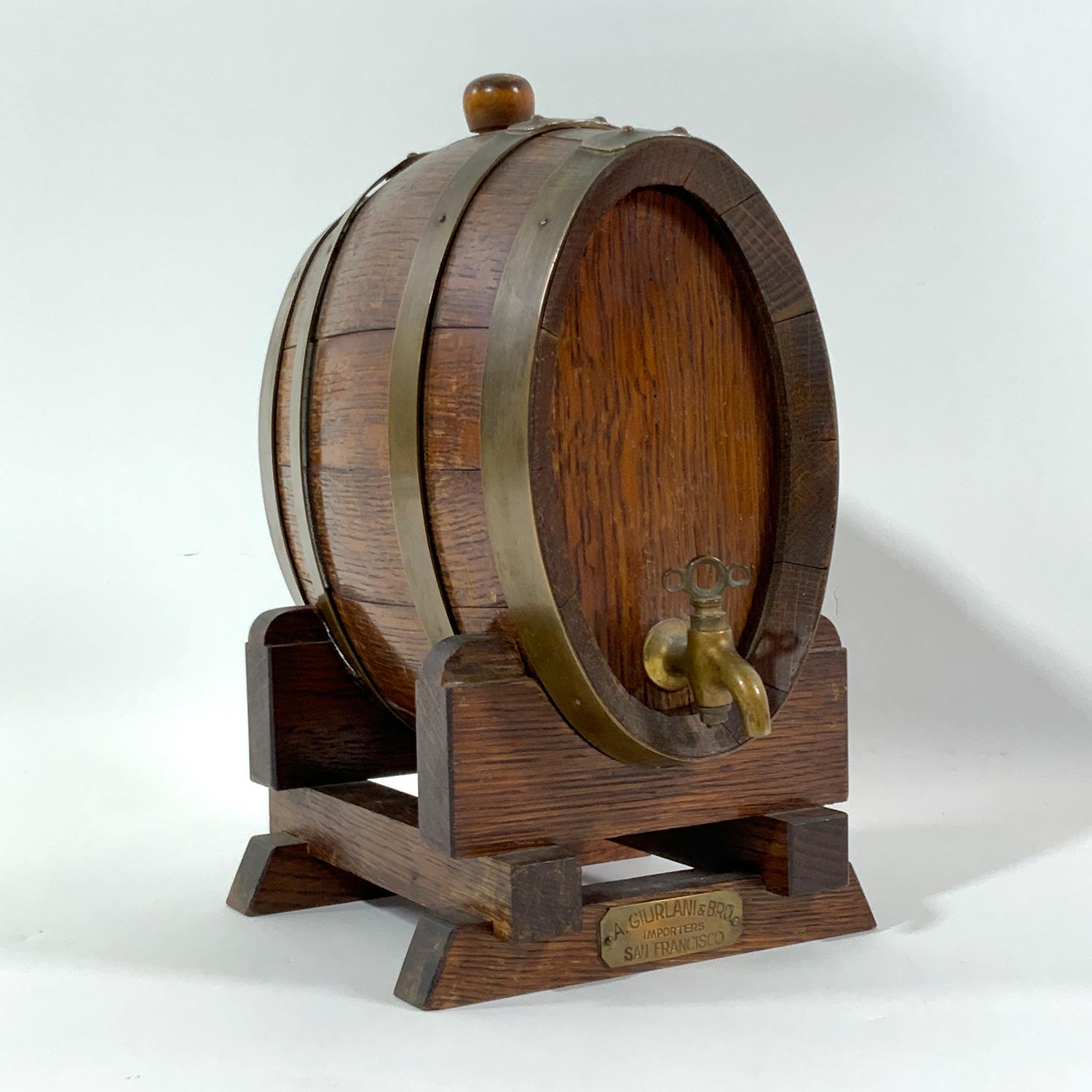 French oak cask on stand for A. Giurlani + Bros Importers, San Francisco. Carefully crafted and stropped barrel with brass bands. Wood cradle. Charming piece Circa 1940. Made in France.