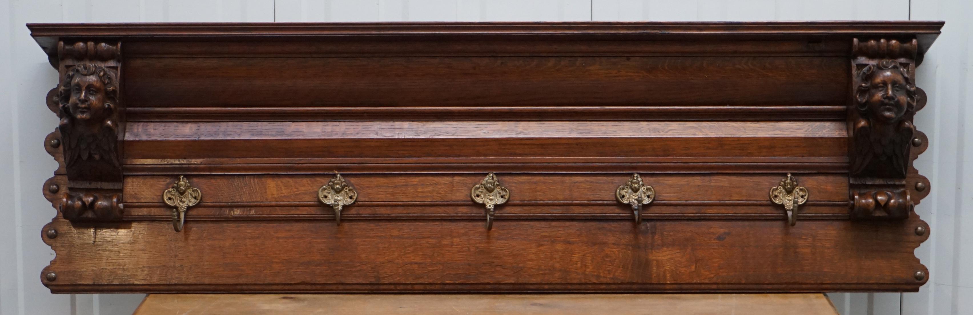 We are delighted to offer for sale this lovely wall mounted solid hand-carved oak utensil or coat rack depicting winged Cherubs

A very old and good looking piece, the coat hooks and side carvings both depict cherubs, the side carvings have wings