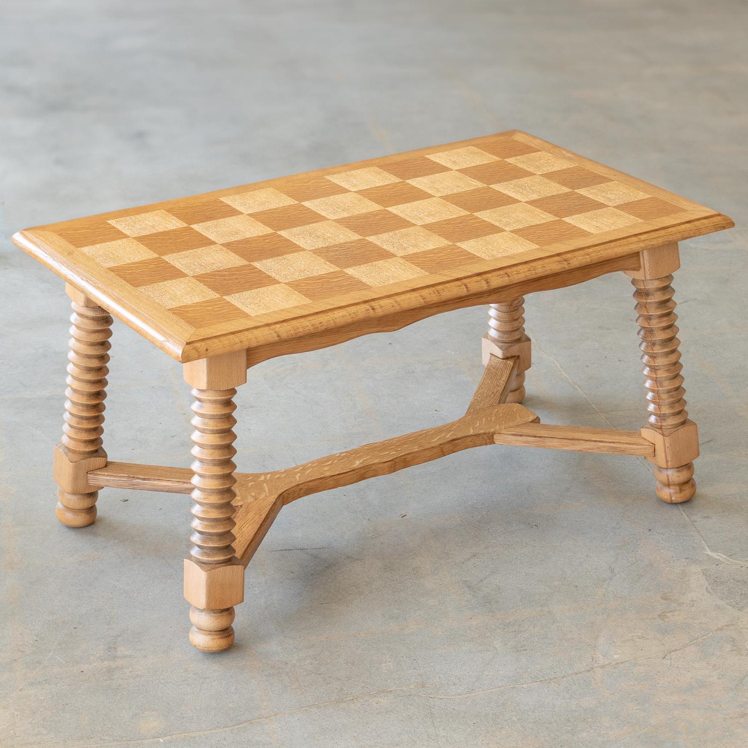 Great light oak wood table by Charles Dudouyt, 1940's. Beautiful checkered wood top with carved wood legs and ball feet. Perfect as a coffee table. Newly refinished in a light stain shows natural grain.