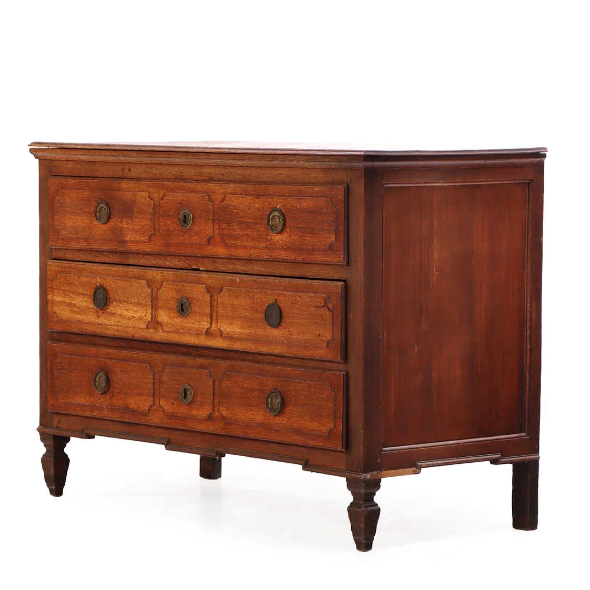 Early 19th Century French Commode is an exceptional and sizeable piece. Its classic rectangular form is supported by refined, turned legs is an understated nod to Louis XVI style influence still present in furniture design at the time.  Constructed