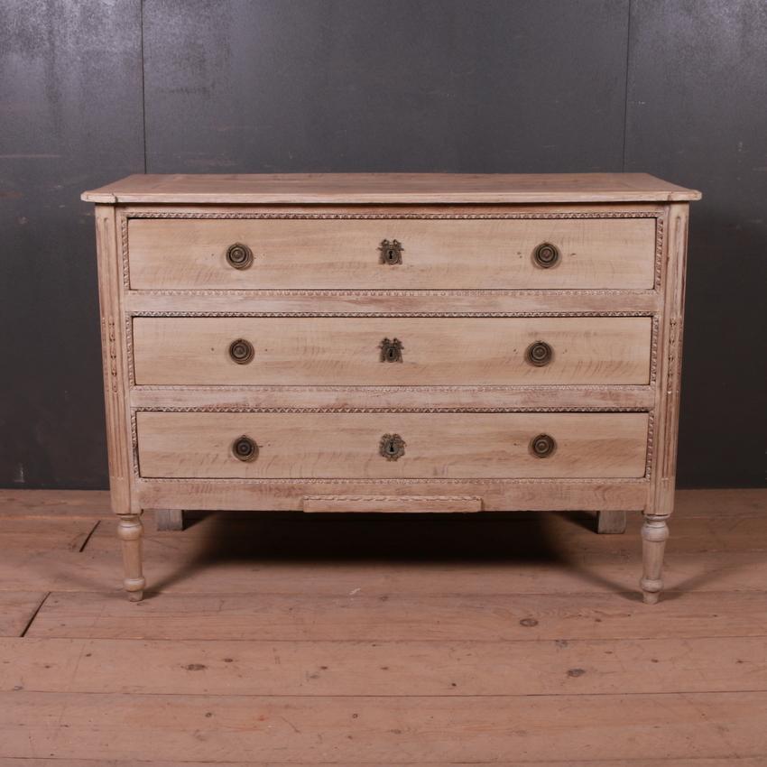 Early 19th century French bleached oak three drawer commode, 1820.

Dimensions
48 inches (122 cms) wide
19.5 inches (50 cms) deep
34 inches (86 cms) high.
