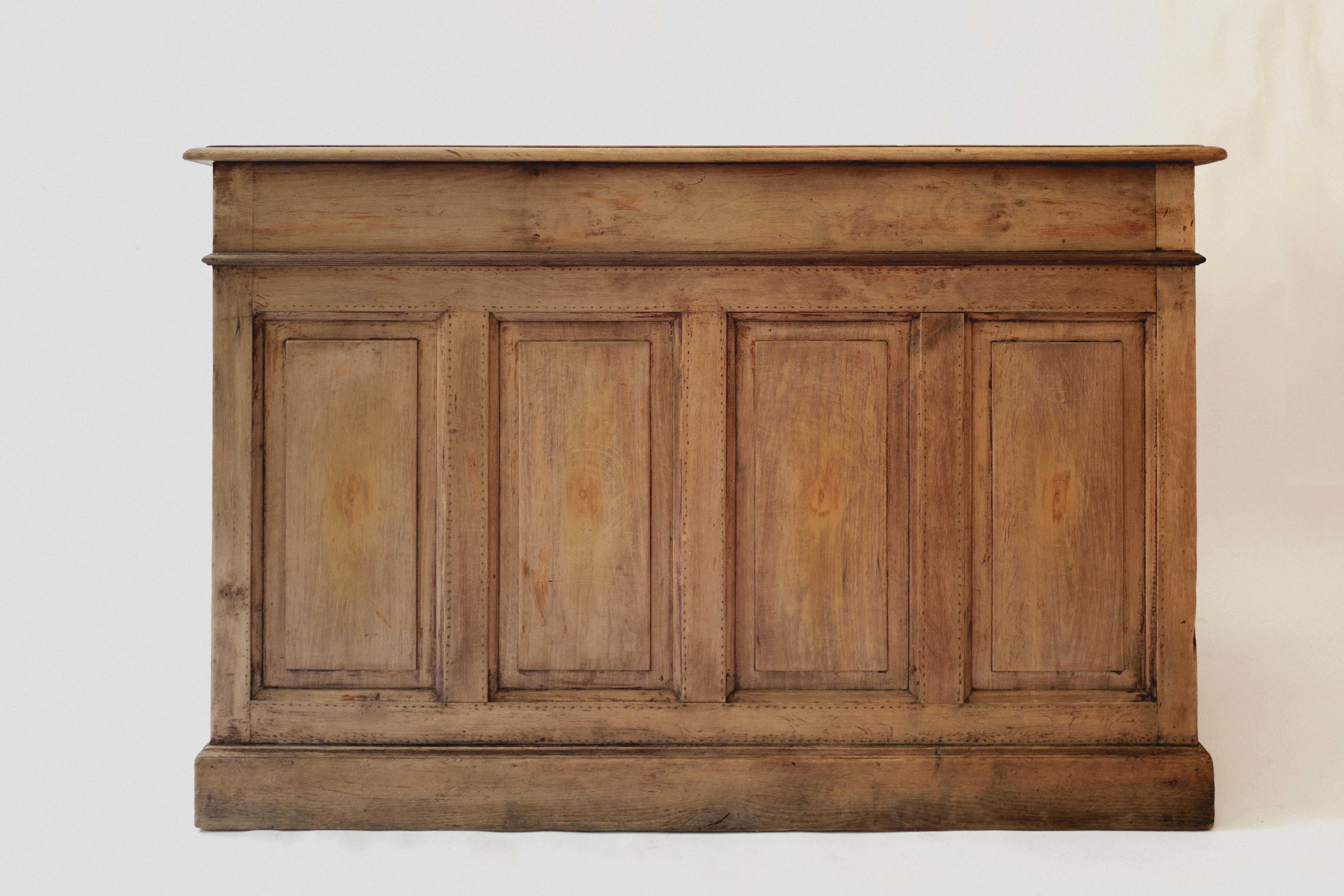 This is a 19th century oak counter from Pichon in Lyon, France. Fantastic condition. It would work beautifully in a hospitality space rather it be a chic hotel check in counter, restaurant check in counter, or retail check out counter. It has two