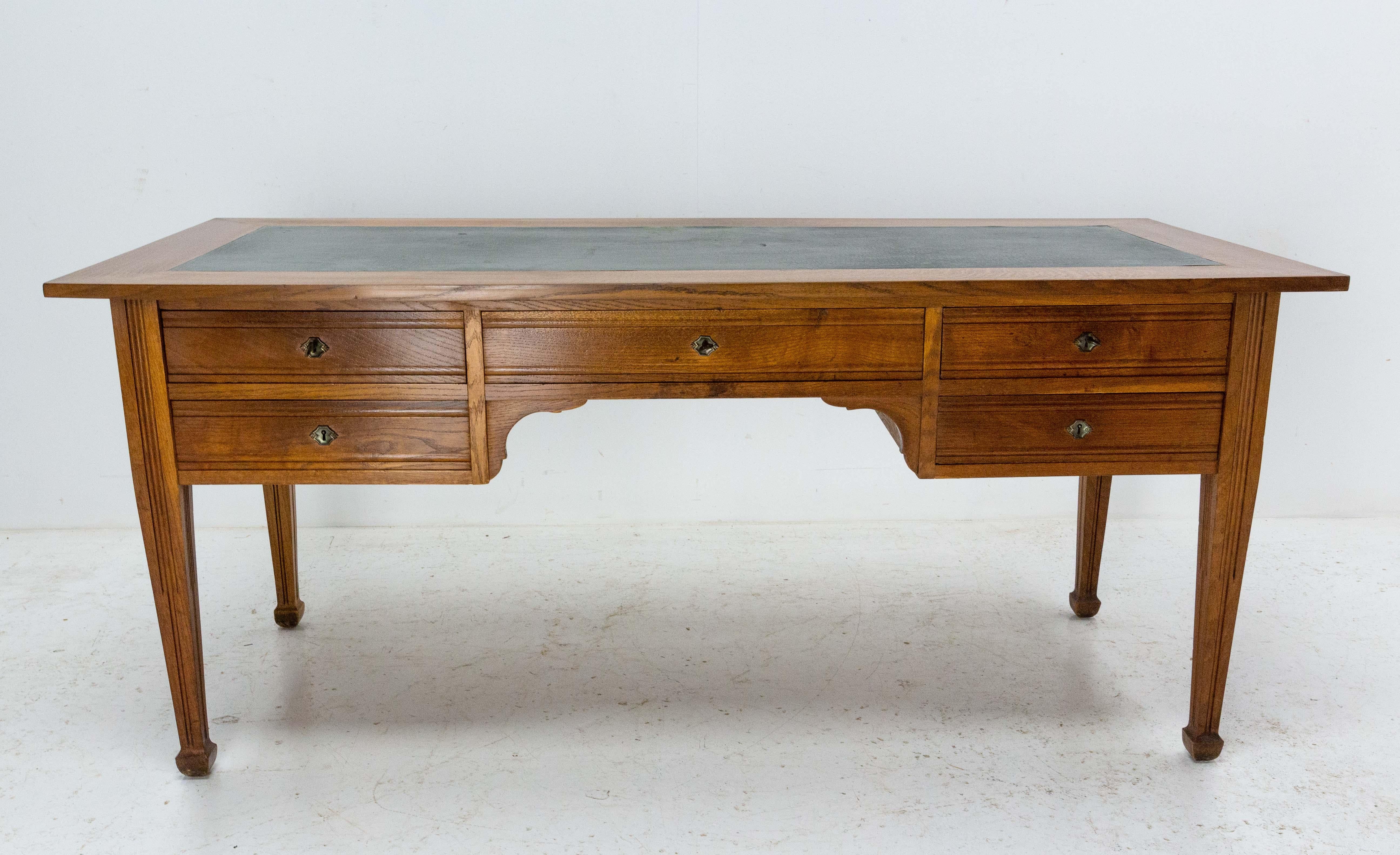 French oak desk with five drawers, circa 1940.
The top of the desk is recovered of coated fabric which can be repainted (see photo).
Leg passage under the desk: 22.44 in. (57 cm)

Shipping: 
L170 P61 H100 136 KG.