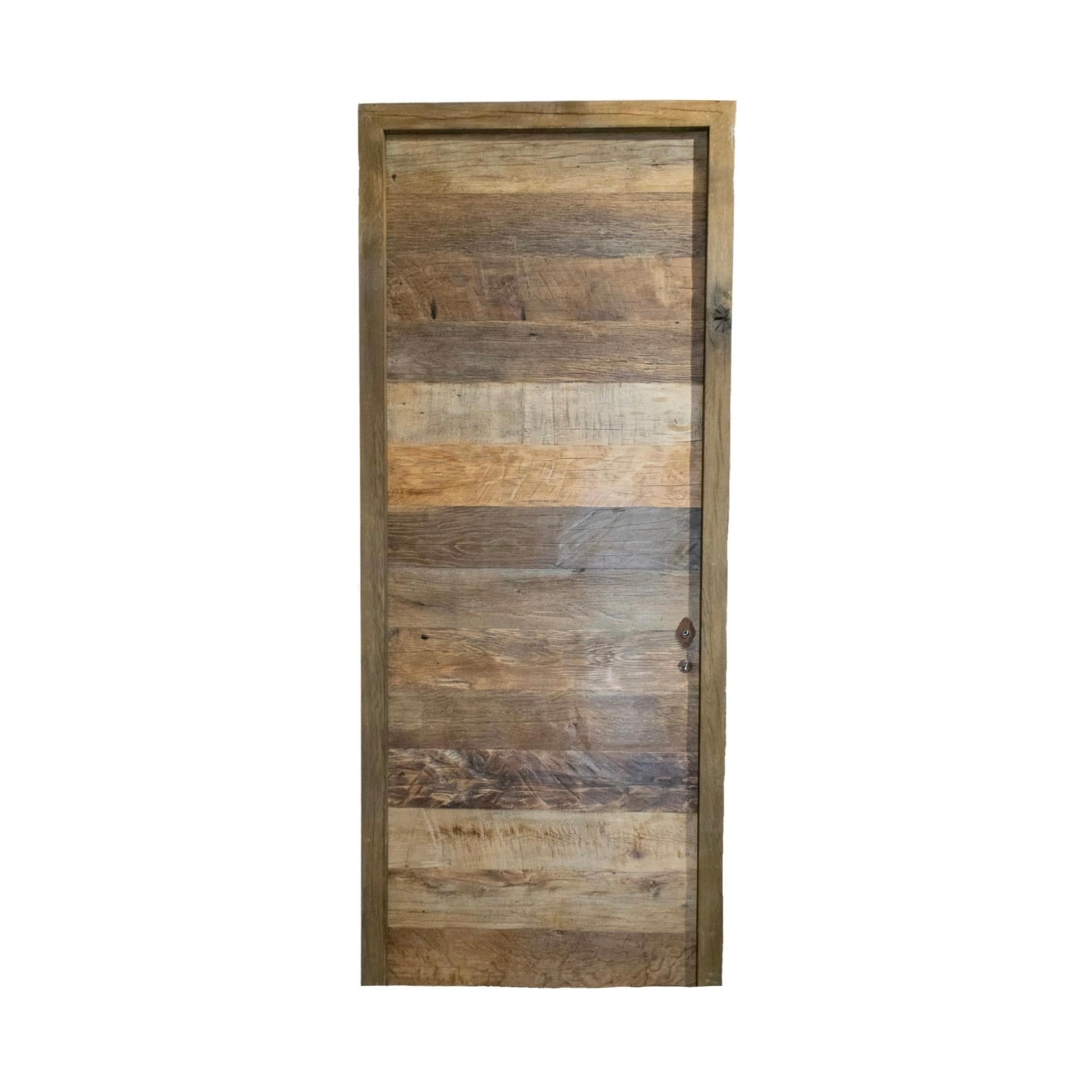 A reclaimed door made out of newly constructed Oakwood. Circa, 18th century. 

Reclaimed rustic doors are doors made from used materials that have been refurbished and given a new purpose. They often have a rustic or vintage appearance, with signs