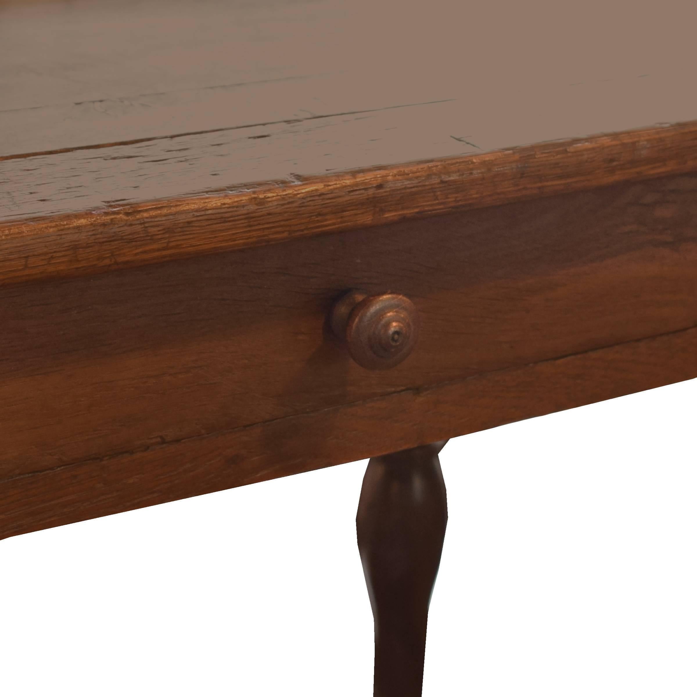 A great early 20th century French oak draper's table with a drawer, low shelf, and six turned legs.