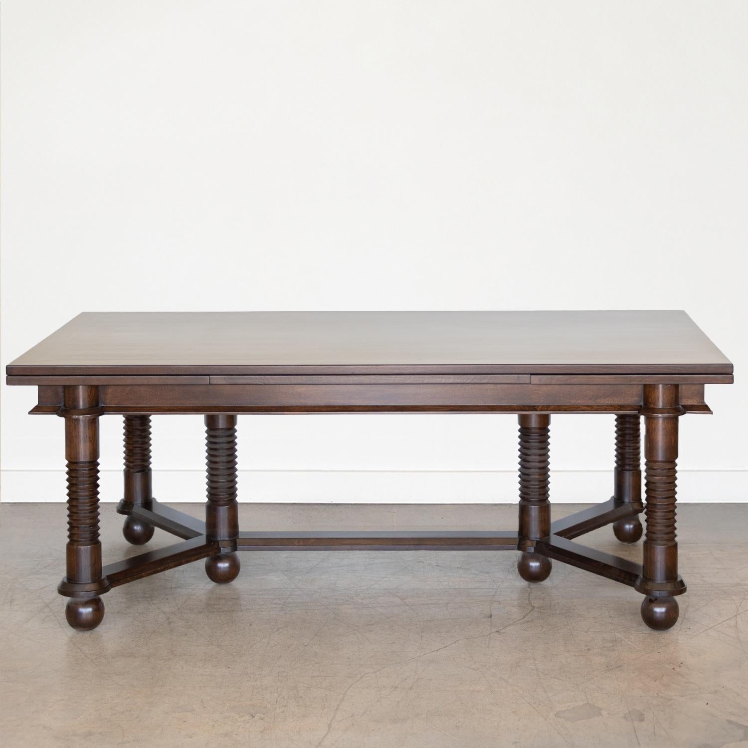 Incredible large wood dining table by Charles Dudouyt from France, 1940s. Rectangular wood top and 7 leg base with carved legs and large ball feet. Dark stain on oak has been refinished and shows beautiful grain. Stunning statement piece, perfect as