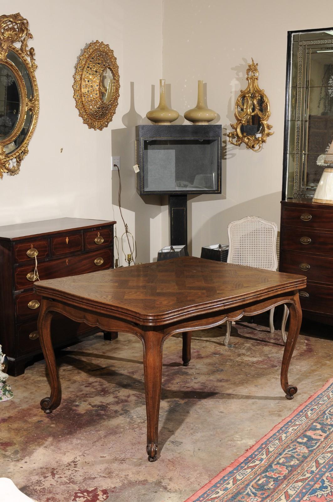 A beautiful French extendable dining table with a lovely parquetry top, scalloped apron and cabriole legs. The 2 leaves are 20 inches each making the overall length 91 inches
Without the leaves the table is 51 inches long.
