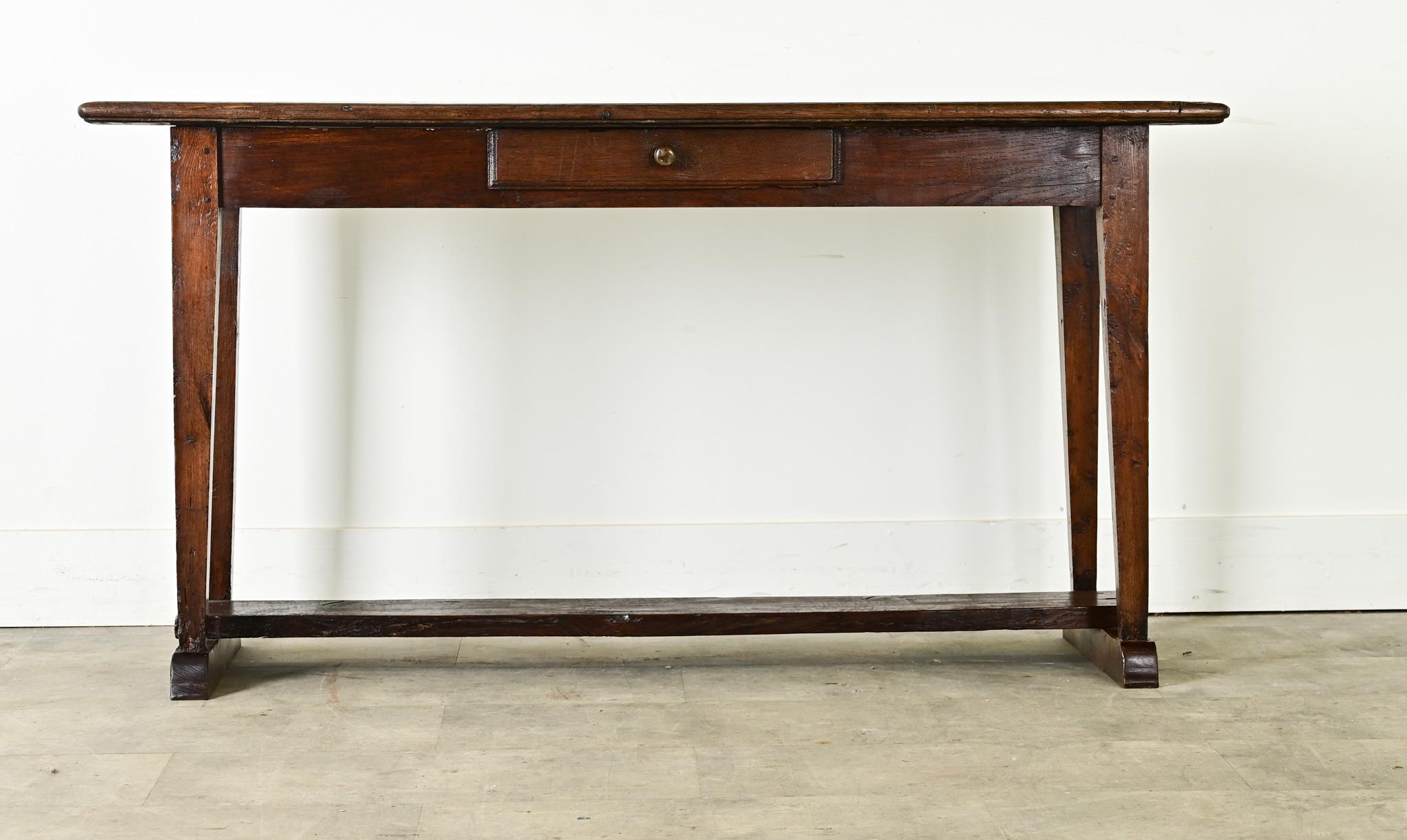 A French country house server from the 19th century in stunning depth of color. The planks of the top surface show knots and wavy grain texture–well patinated and nearly ebonized from nearly two centuries of use–outlined with a low, routed edge.
