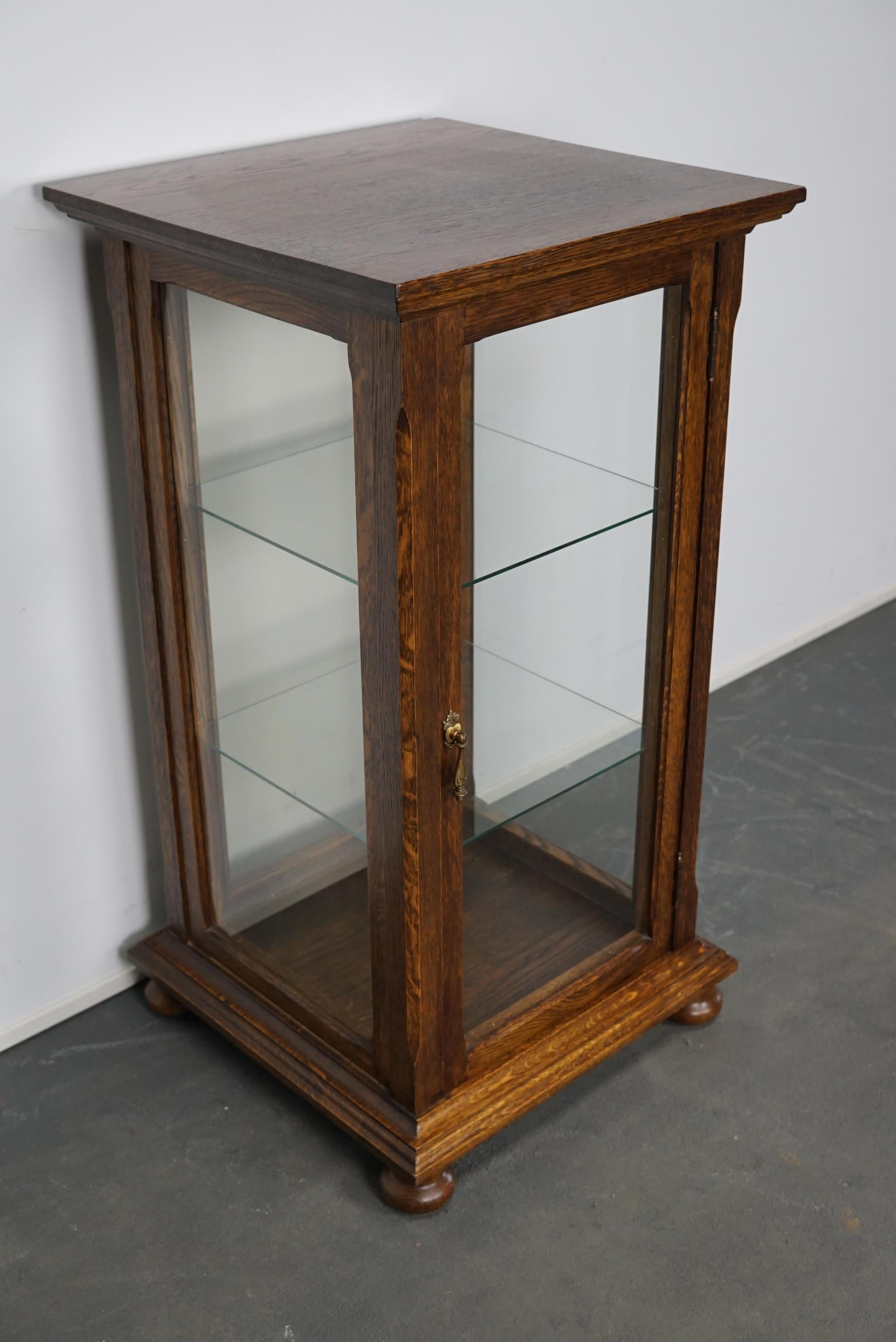 This oak shop vitrine was made in France, circa 1950s. It was used to display items in a shop.