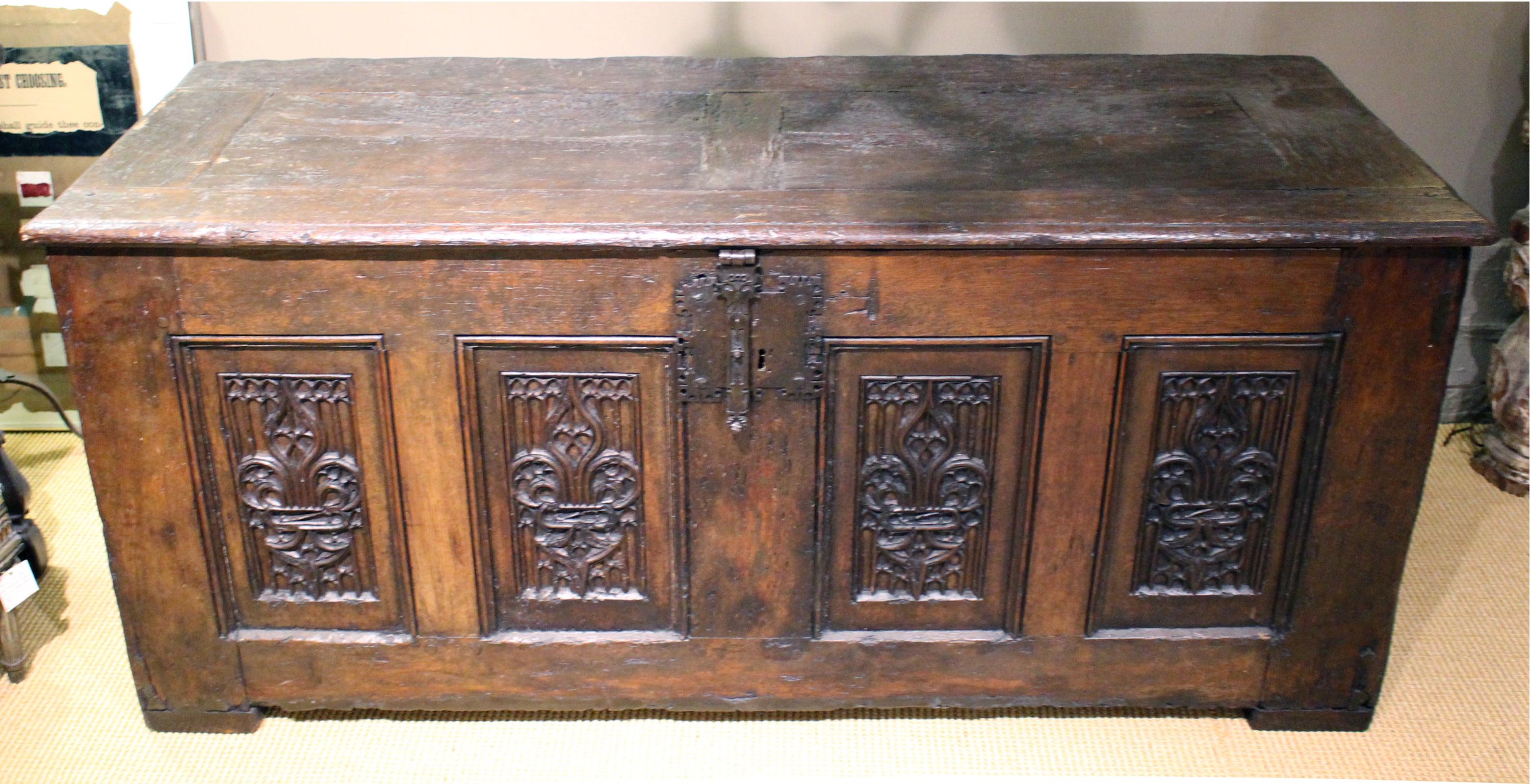 French oak Gothic coffer. Four carved front panels, simple linen fold side panels. Iron lock.